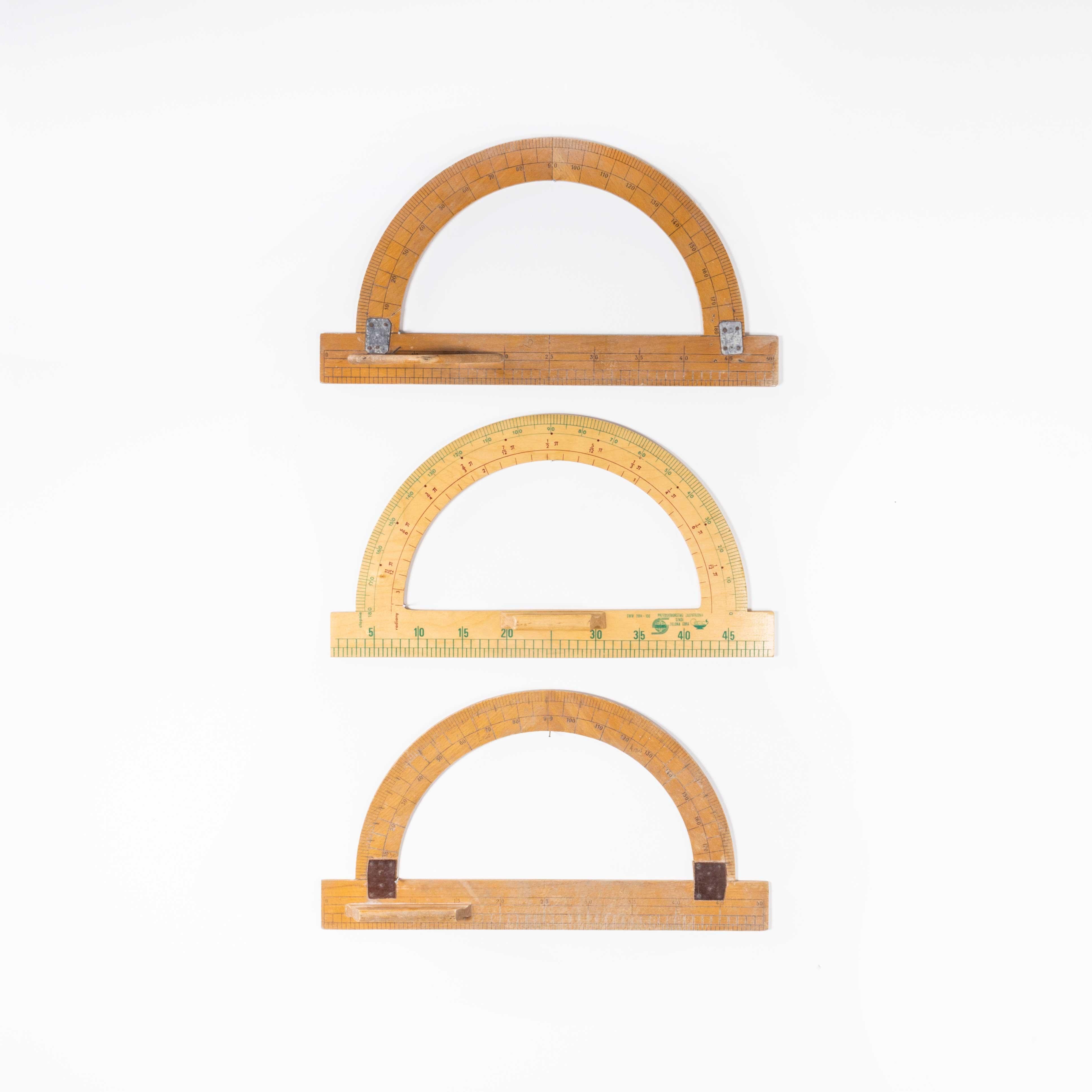 Set of three large semi cicular stationery oversize protractors
Set of three large semi circular stationery shapes. Three protractor shapes made of wood, each shape approximately 50 x 28cm.

WORKSHOP REPORT
Our workshop team inspect every