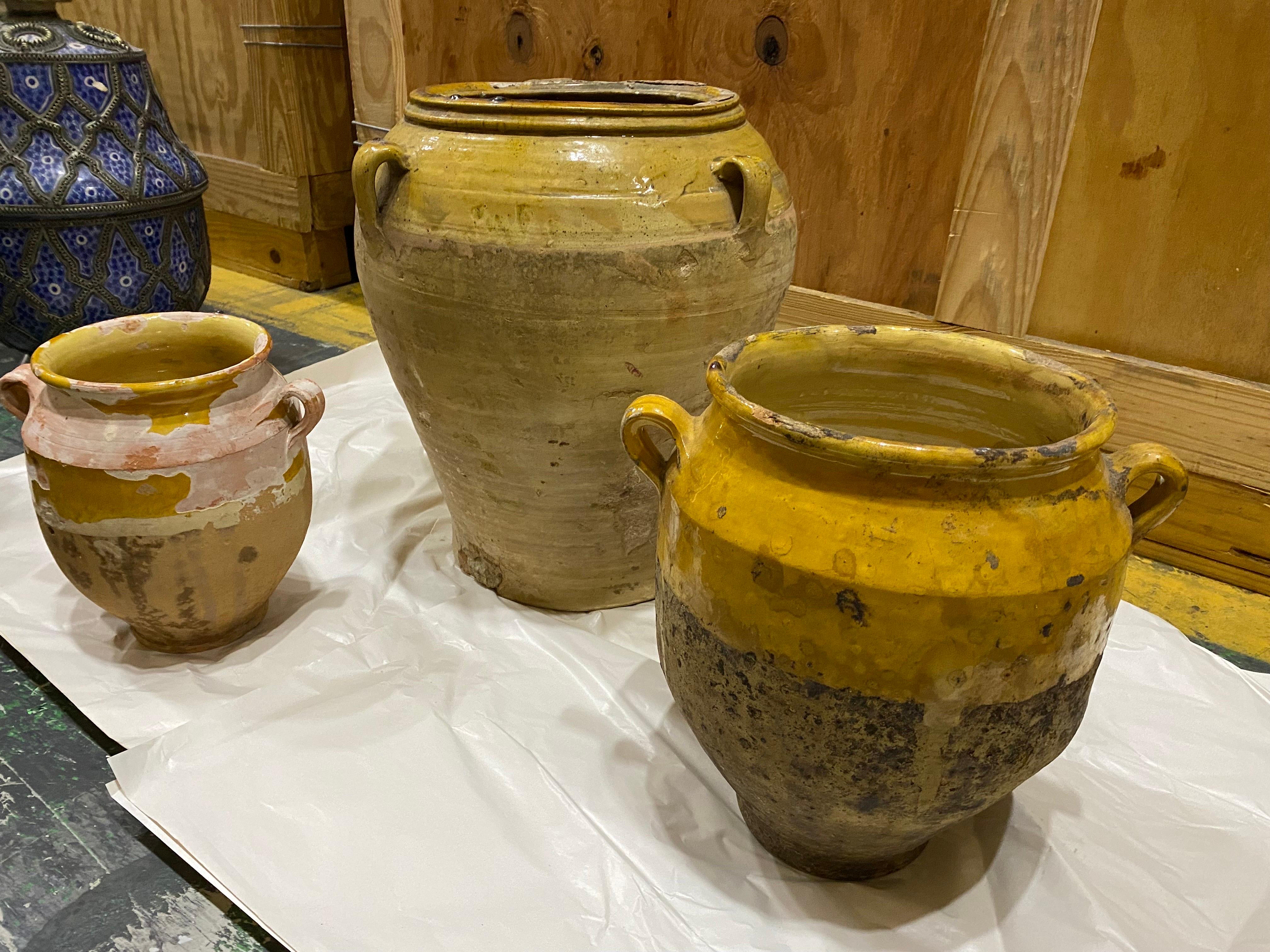 Set of Three Late 19th C. French Provinical Terracotta Yellow Confit Pots
Three sizes of traditional earthenware pottery confit pots from South West France with yellow glaze. Lovely decorative pieces which look good as a group.

Largest with four