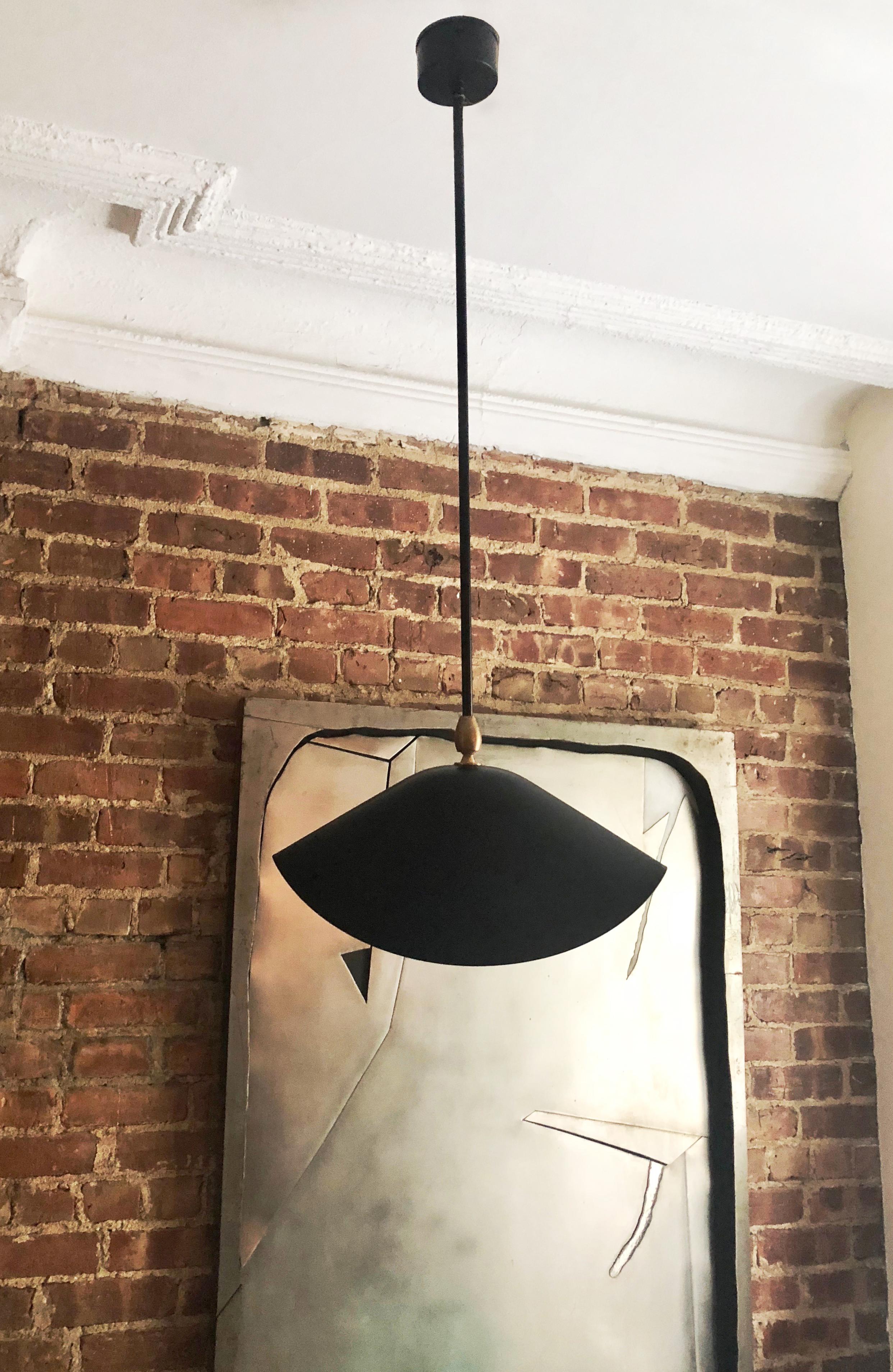 Three ceiling lights in black and white enameled metal each has a 24 inch stem with an  articulating shade and a brass fitting. Designed by Serge Mouille in 1950's. All three lights were produced in France 2005.
Priced per Light!!
