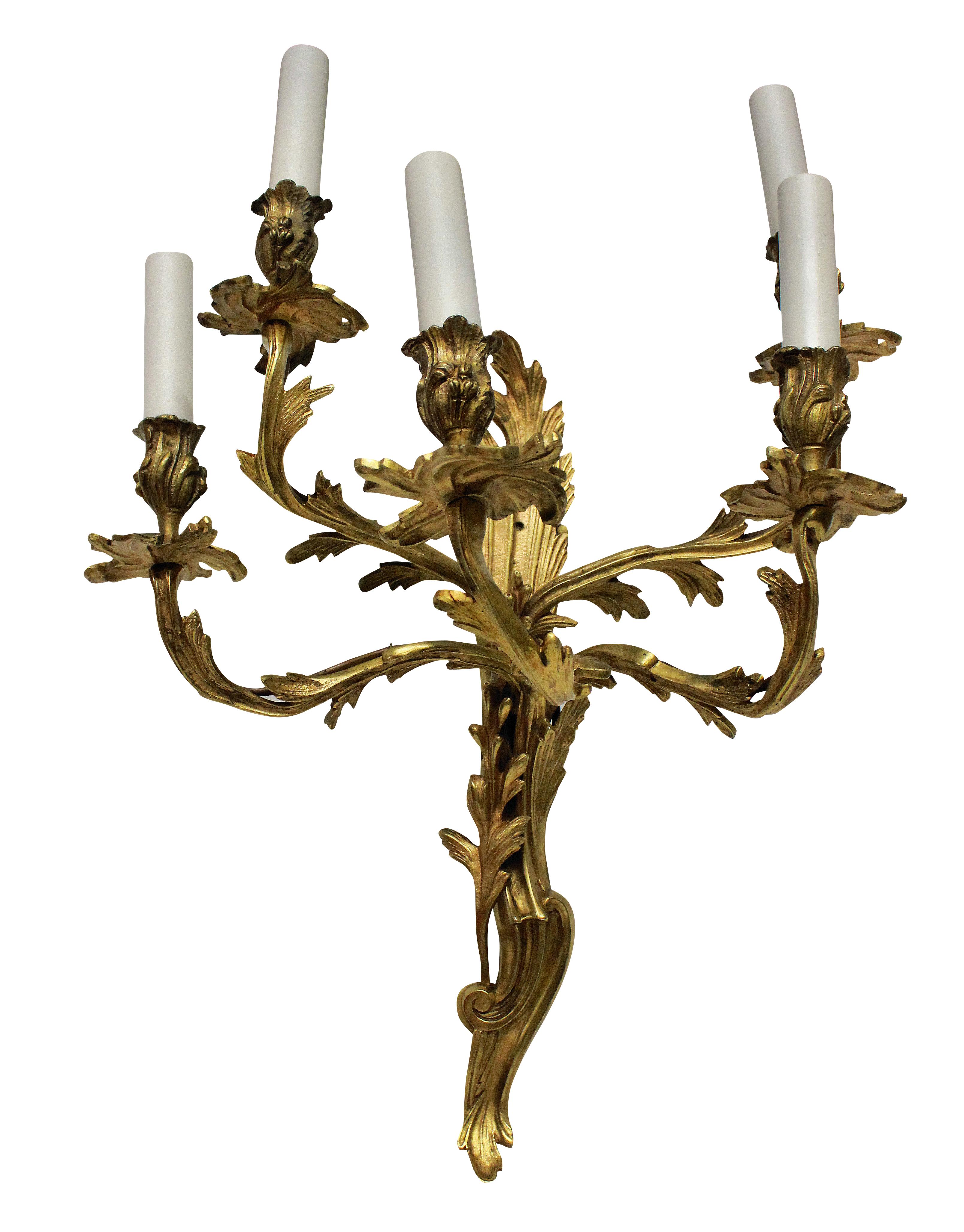 A set of three large Louis XV style gilt bronze, five branch wall sconces.