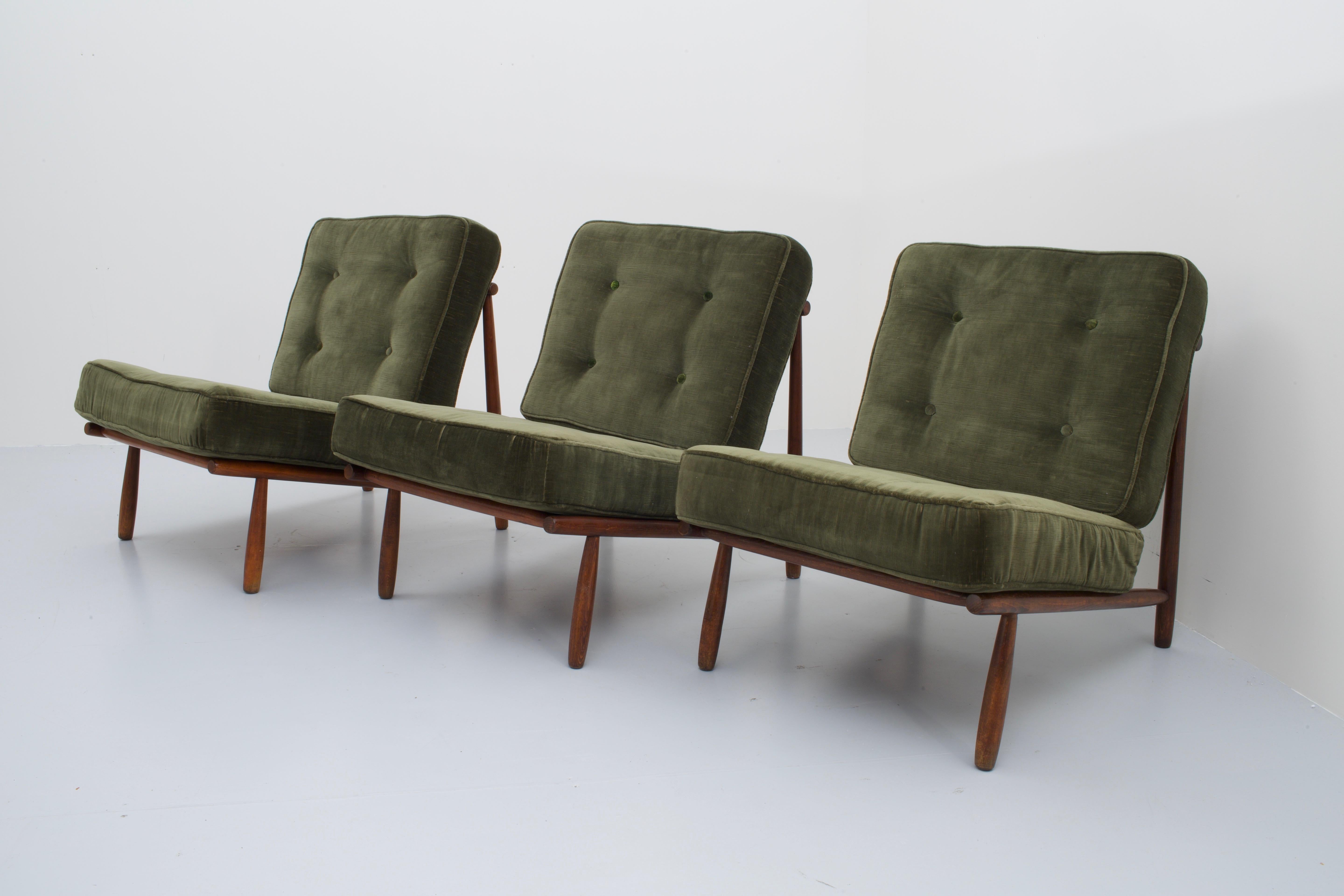 Set of three lounge chairs in beech and dark green velvet by Alf Svensson for DUX in very good condition. These Scandinavian chairs can be positioned separately from one another or can be combined forming one big three-seat sofa. The frame consists