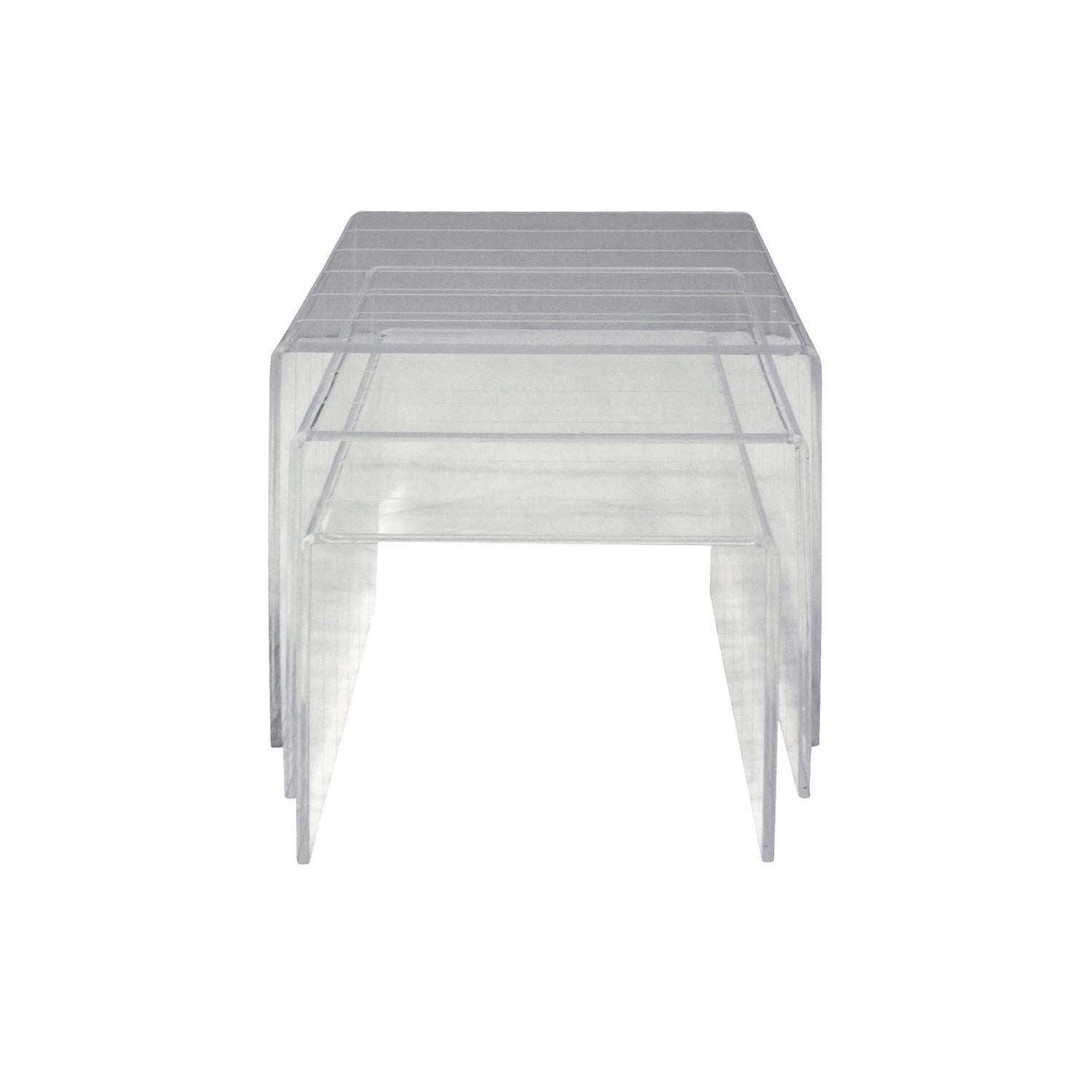 Set of three nesting tables in Lucite with incised lines, American, 1970s.

Largest table: 
W 12 inches
D 17 inches
H 16 inches.