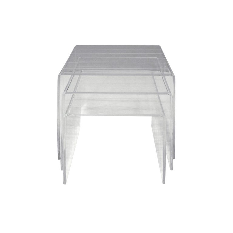 Set of three nesting tables in Lucite with incised lines, American, 1970s.

Largest table: 
W 12 inches
D 17 inches
H 16 inches.