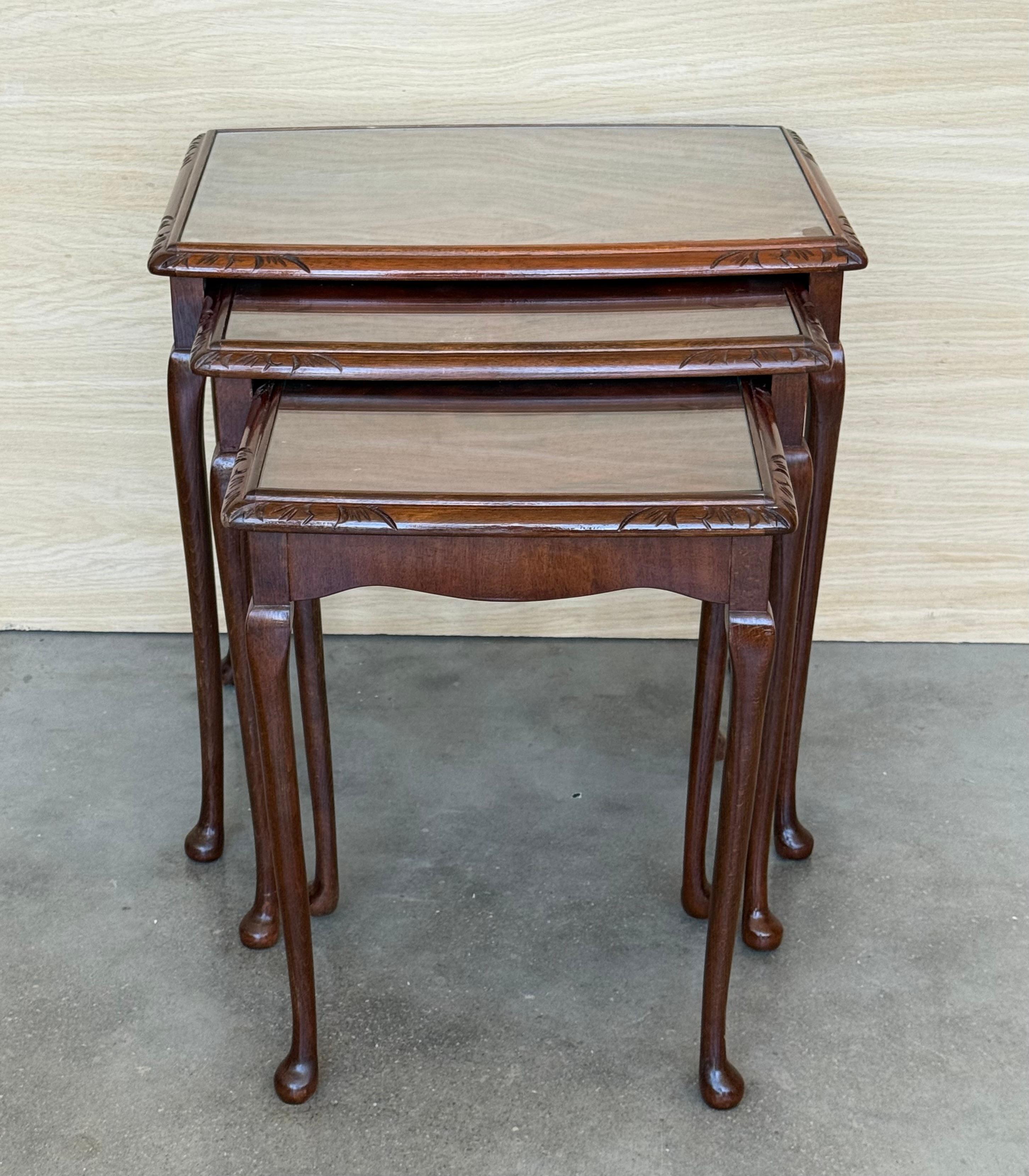 The Chippendale Nesting Tables from Spain features three tables, all with attractive mahogany tops surrounded by a lovely molding which helps prevent items sliding off of the tables. Supported on hand carved, solid mahogany legs the smallest table