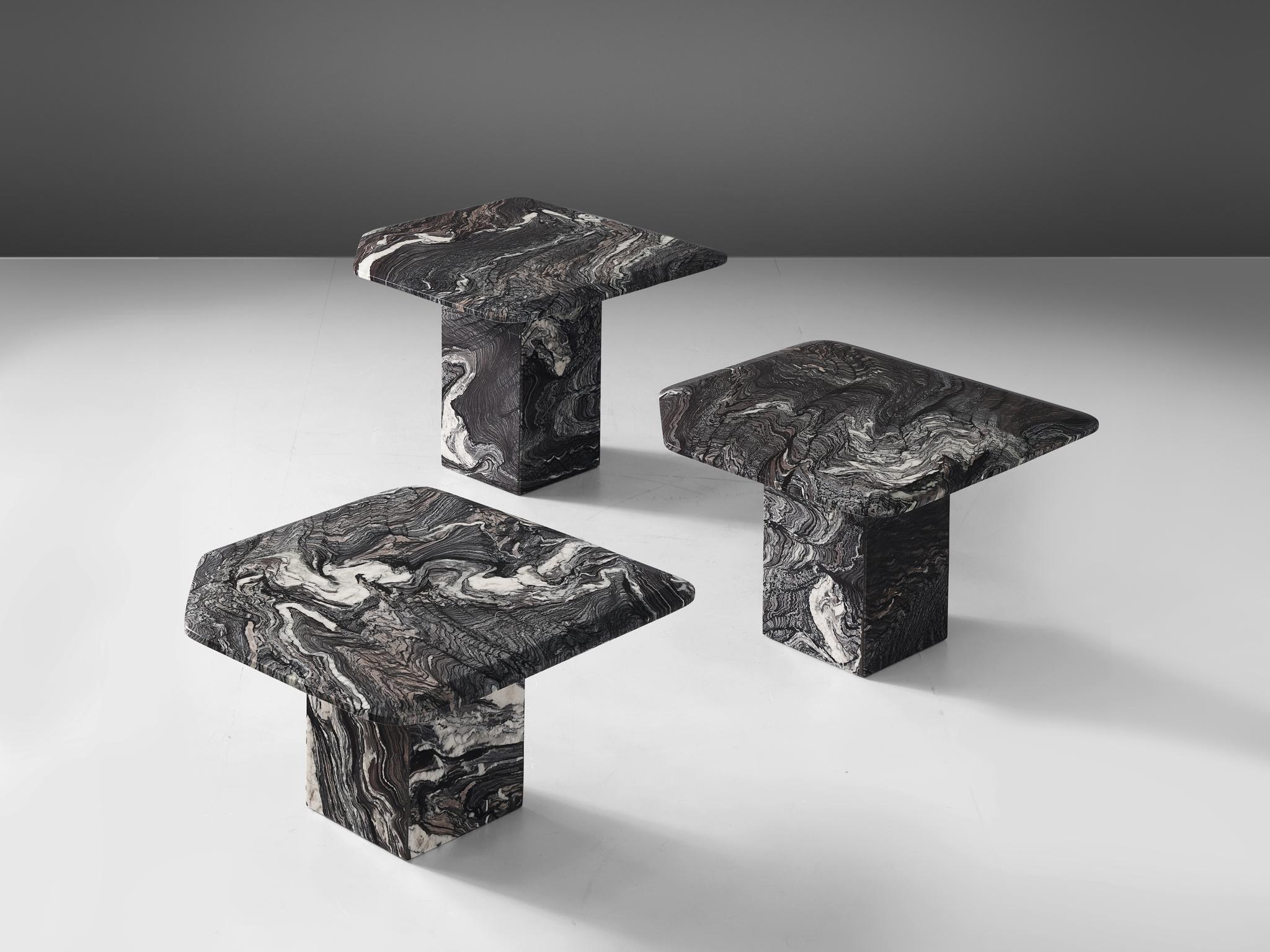 Set of three side tables, marble, Italy, 1980s.

A set of cocktail tables in grey marble with a extraordinary veins. The side tables feature squared shaped bases of different heights. The tops are squared as well, with a corner cut off. The edges