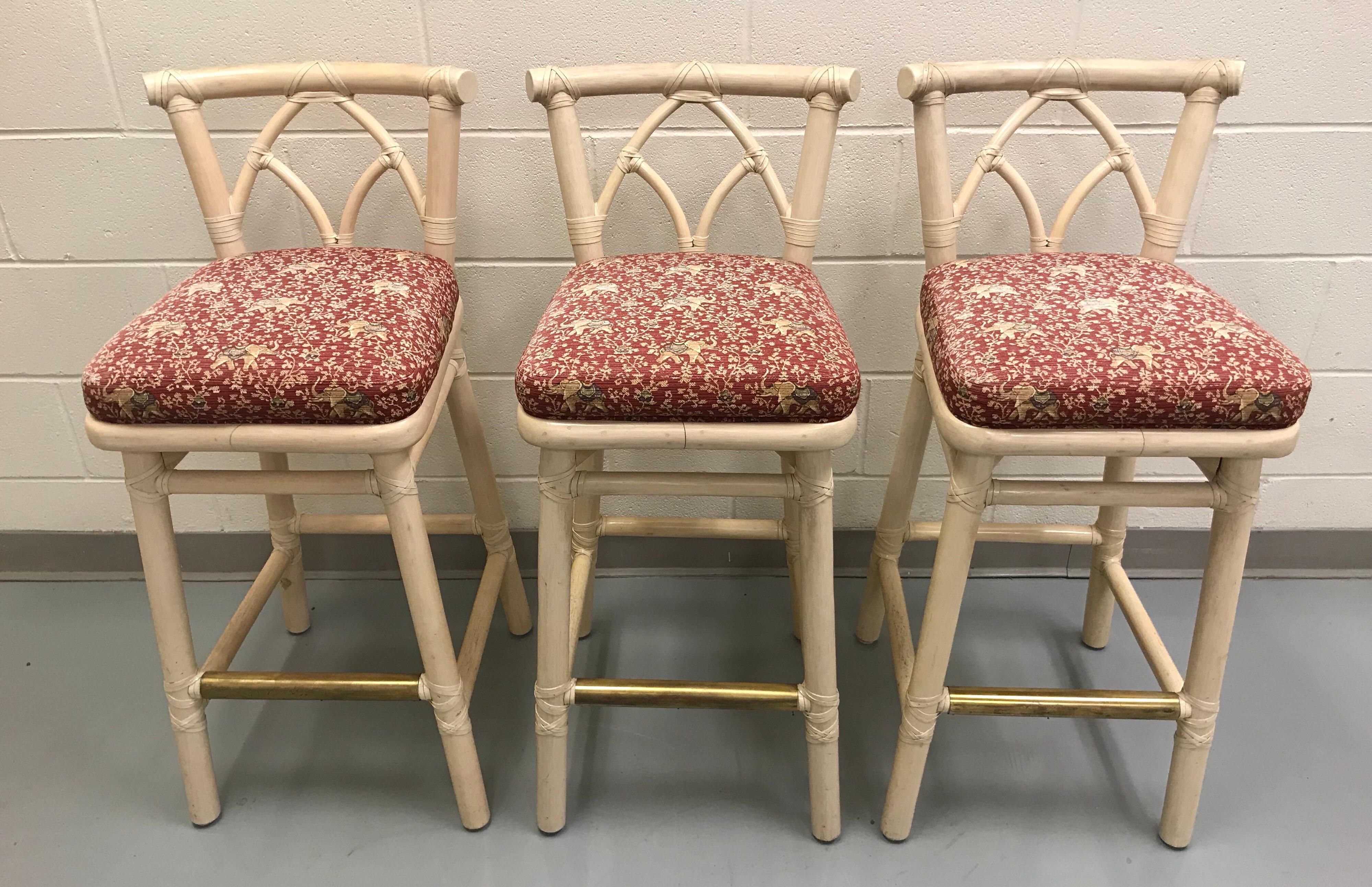 Set of three McGuire bamboo bar or counter stools with a brass footrest