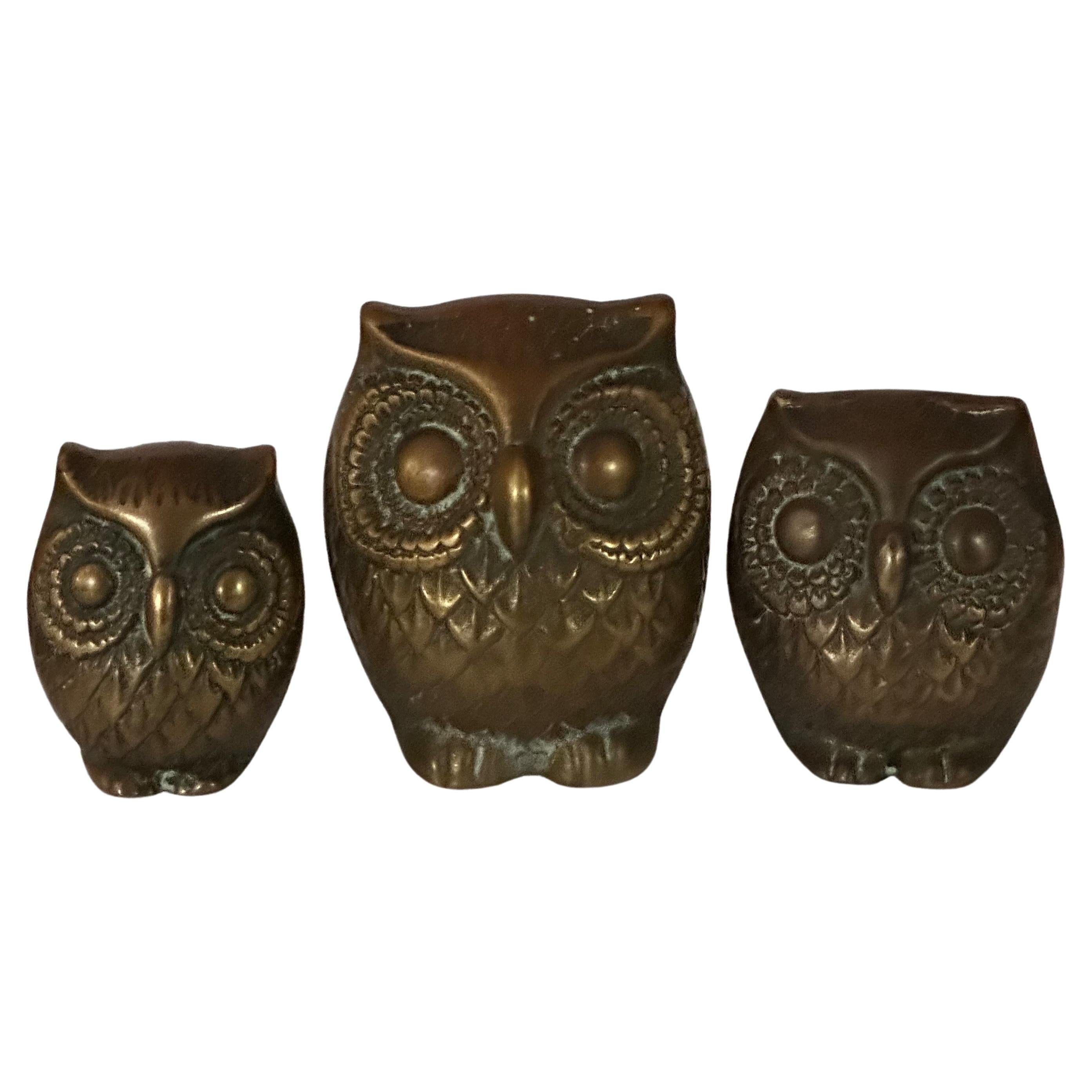 A really cool set of three MCM brass owl sculptures, circa 1960s. The owls are in very good vintage condition with and the largest owl measures 2.5