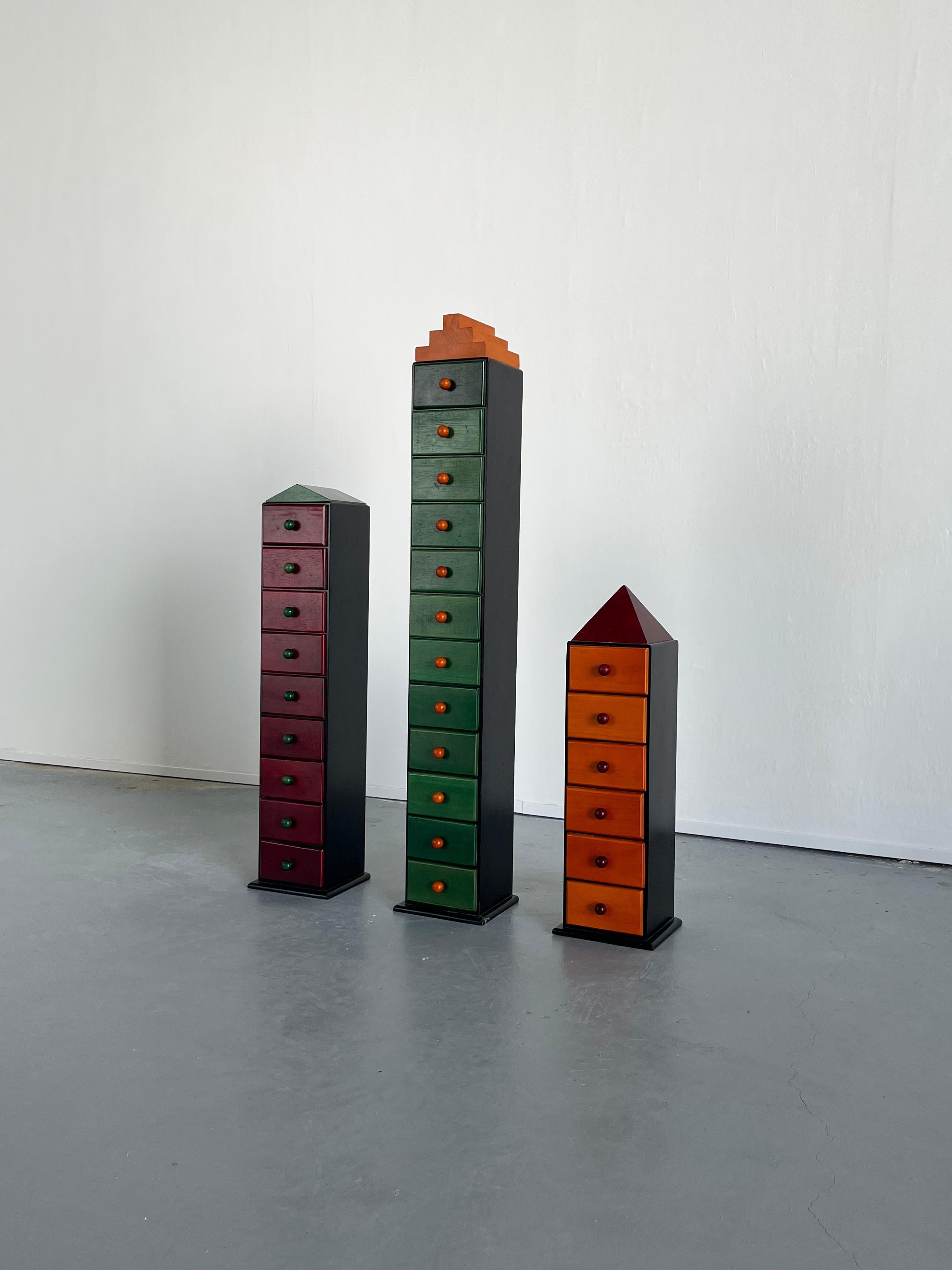 Set of three unique vintage postmodern storage cabinets following the Memphis Milano style, produced in The Netherlands in the 1970s.
The set can serve as a unique postmodern Memphis decoration or storage cabinets featuring a total of 27 small
