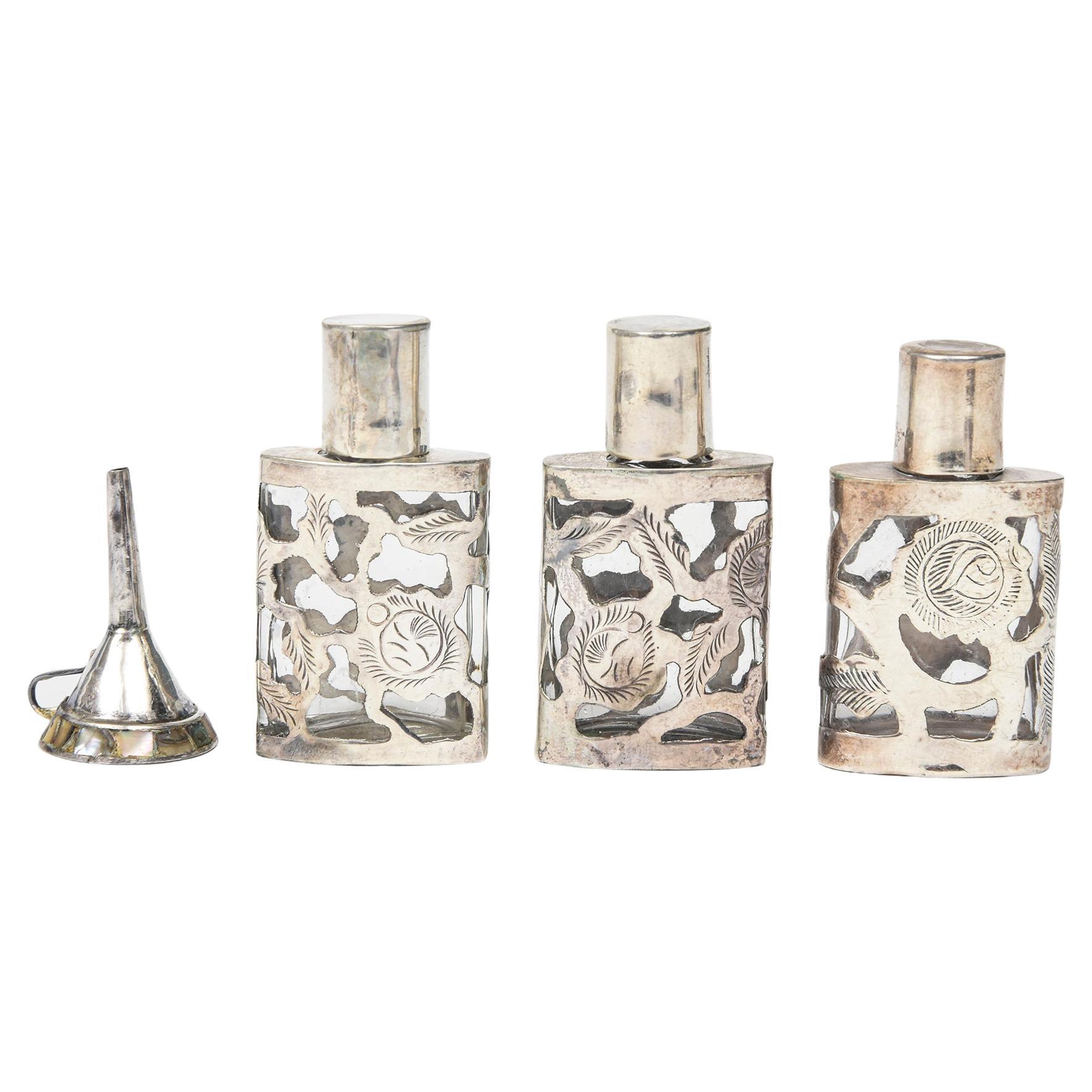 Set of Three Mexican Floral Sterling Silver Overlay Perfume Bottles with Funnel For Sale