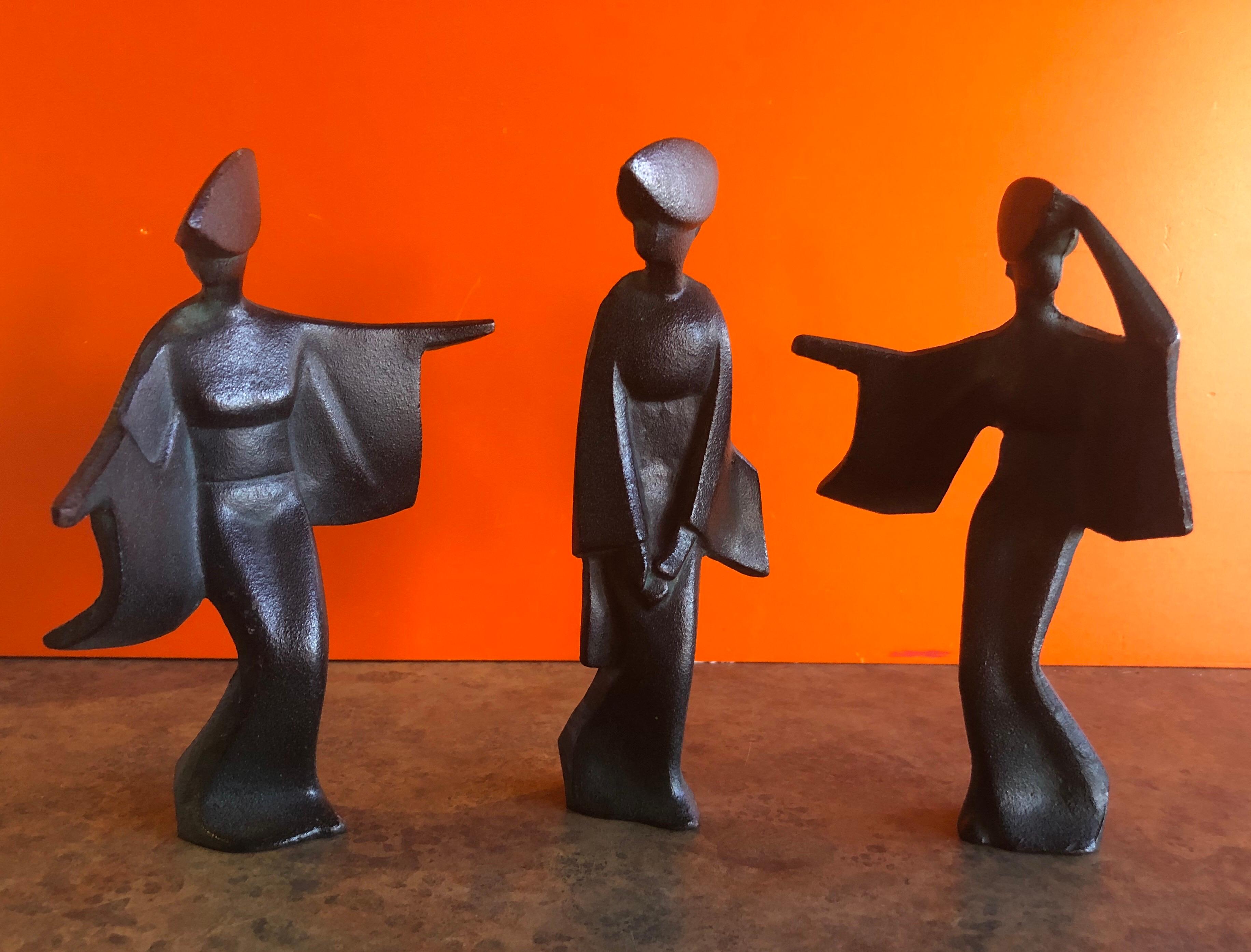 A very cool set of three Japanese geisha figurines, circa 1960s. The pieces are cast iron with verde gris finish and are quite heavy; they would make a great Mid-Century Modern accent in any space! #1128.