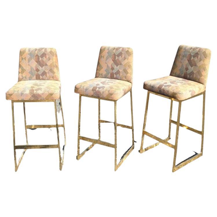 Ensemble de trois tabourets de bar tapissés ton or de style moderne du milieu du siècle dernier