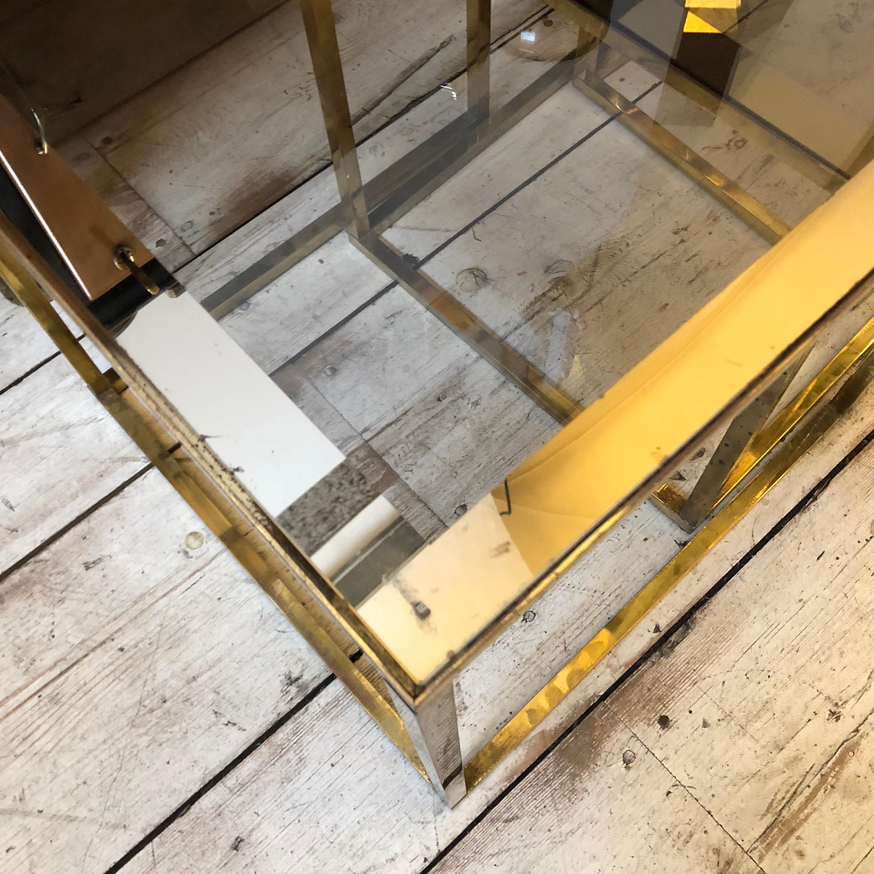 Three Mid-Century Modern square modular smoked glass and brass side tables, brass it's in original patina and glass are in good conditions