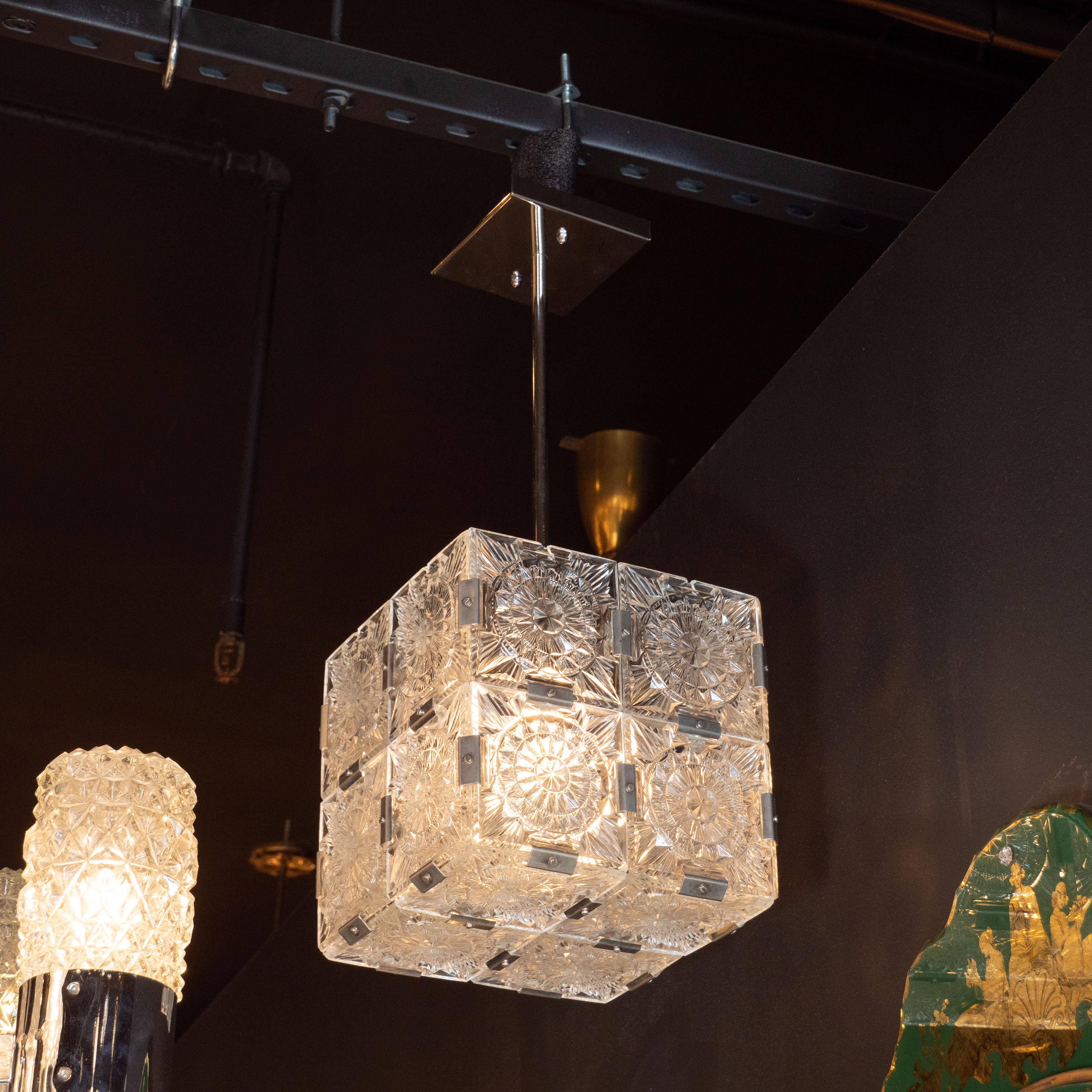 These elegant Mid-Century Modern cube pendants were produced circa 1950 by the renowned Austrian maker Kinkeldey. Each side features four glass panels etched with an elaborate starburst pattern resembling an abstracted and illuminated woodcut print