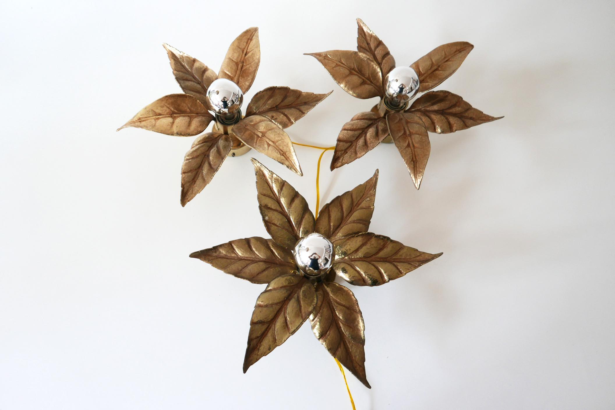 Set of three amazing Mid-Century Modern floral brass wall lamps or sconces. Designed by Willy Daro for Massive Lighting, 1970s, Belgium.

The lamps are executed massive cast brass and each lamp needs 1 x E27 Edison screw fit bulb. They are wired, in