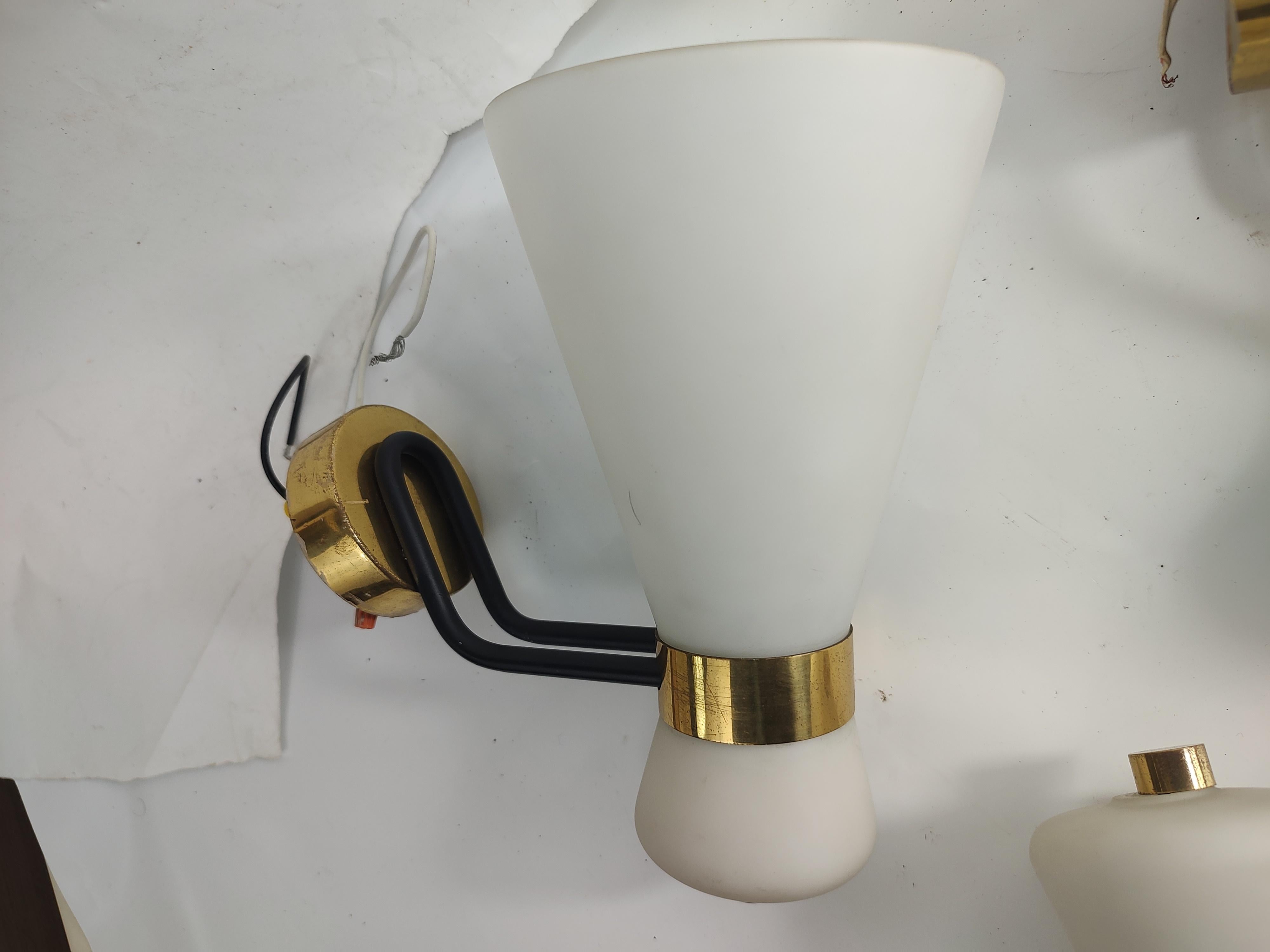 Fantastic set of 3 single light wall sconces with frosted glass shades. Brass collar connected by a double black iron tube which in turn connects to a brass wall mount plate. In excellent vintage condition with minimal wear, age related. Wiring is