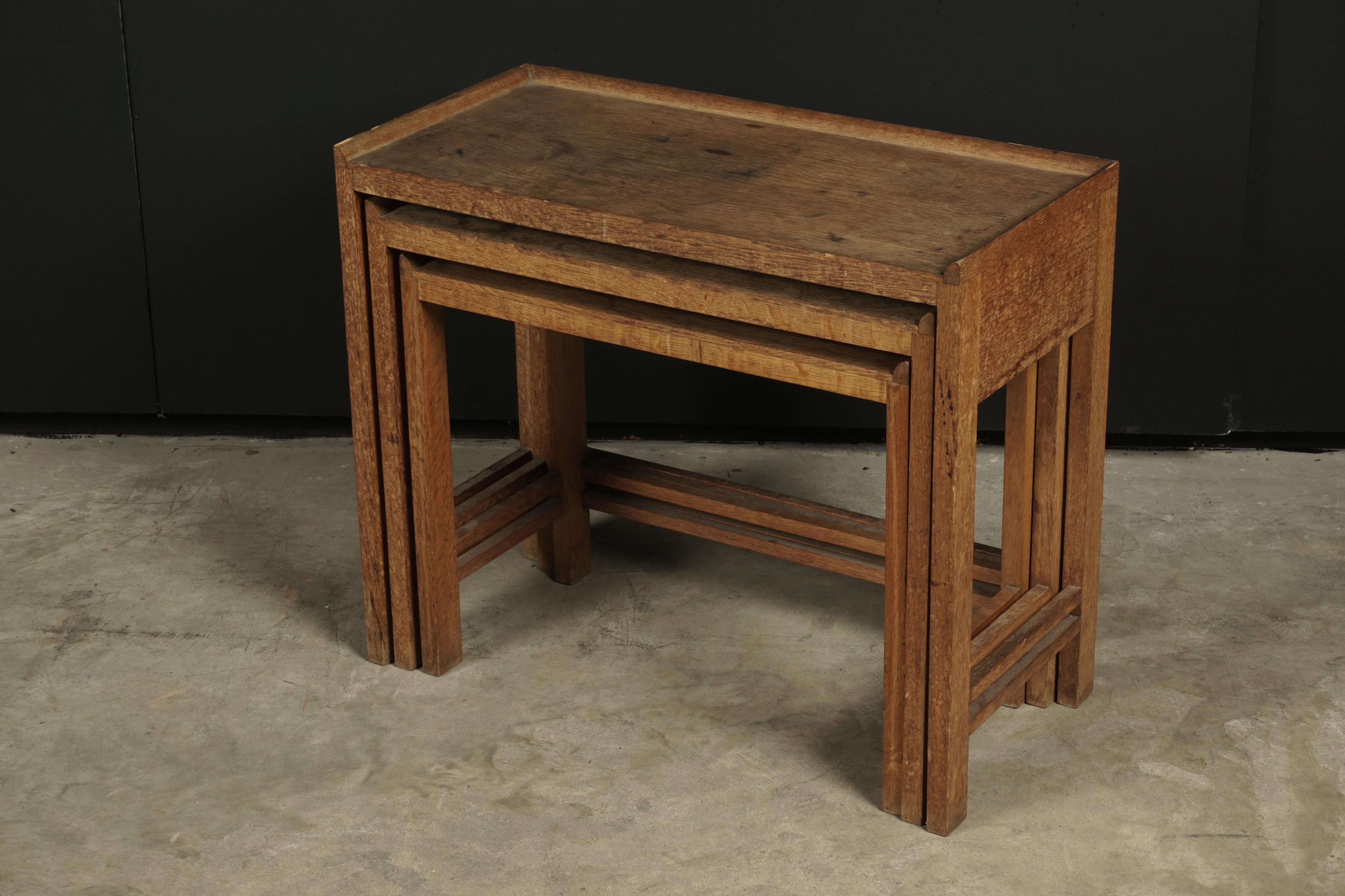 Set of three midcentury nesting tables from France, circa 1950. Solid oak construction with original patina.