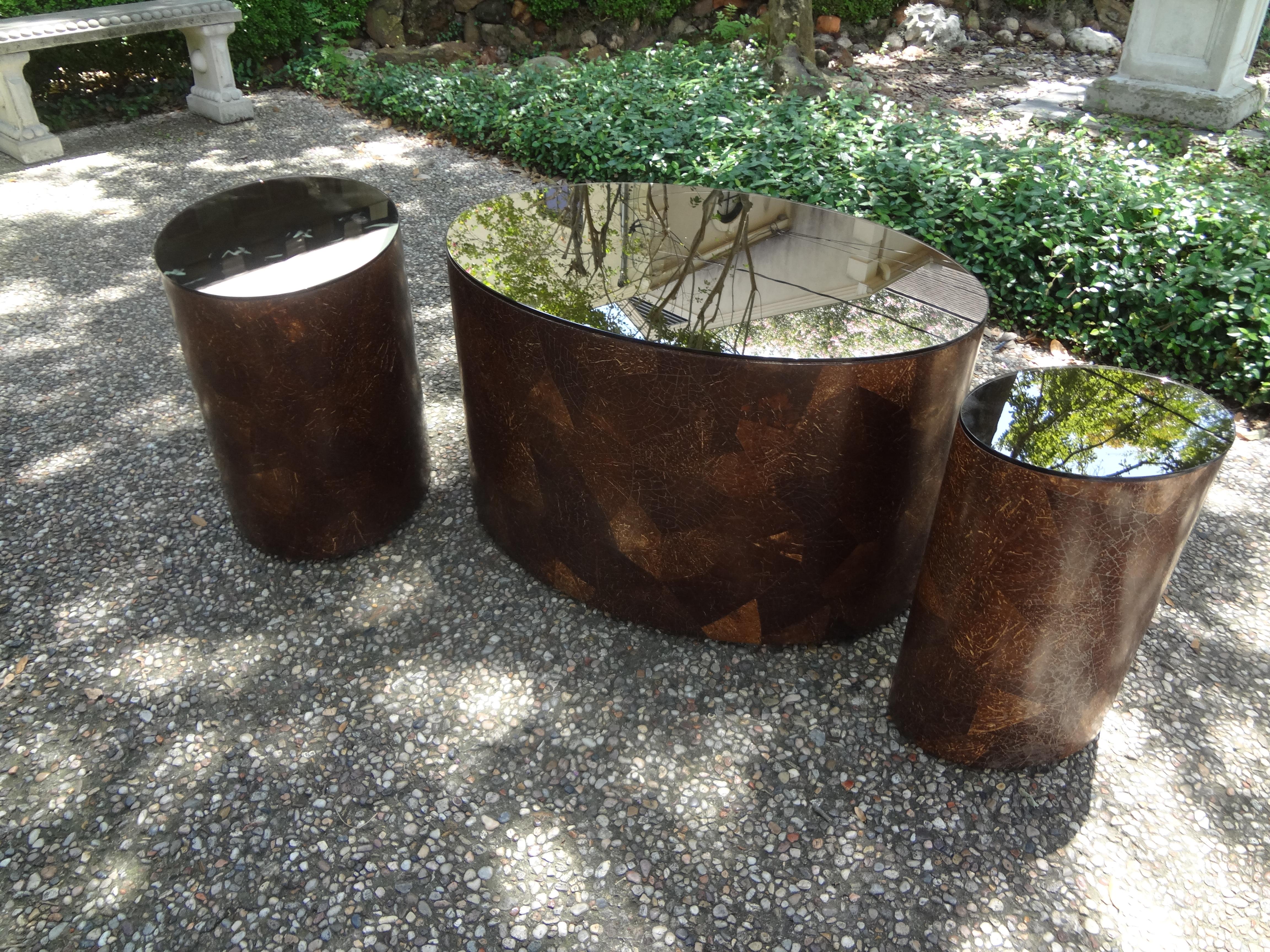 Karl Springer style oval coconut shell tables with bronze mirrored tops.
Fantastic set of 3 mid-century Karl Springer style oval coconut shell tables with bronze mirrored tops. This rare set of vintage coconut shell tables could be used together to