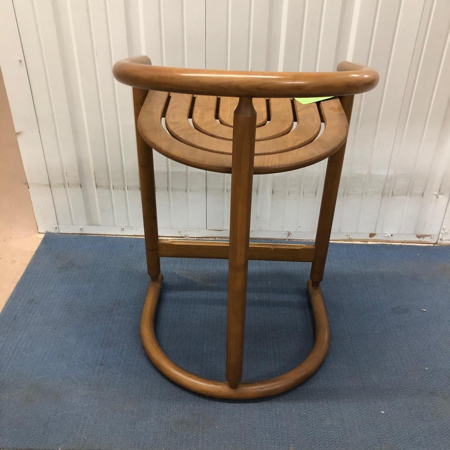 A set of three handsome midcentury bar stools in medium colored wood. Measures: 32