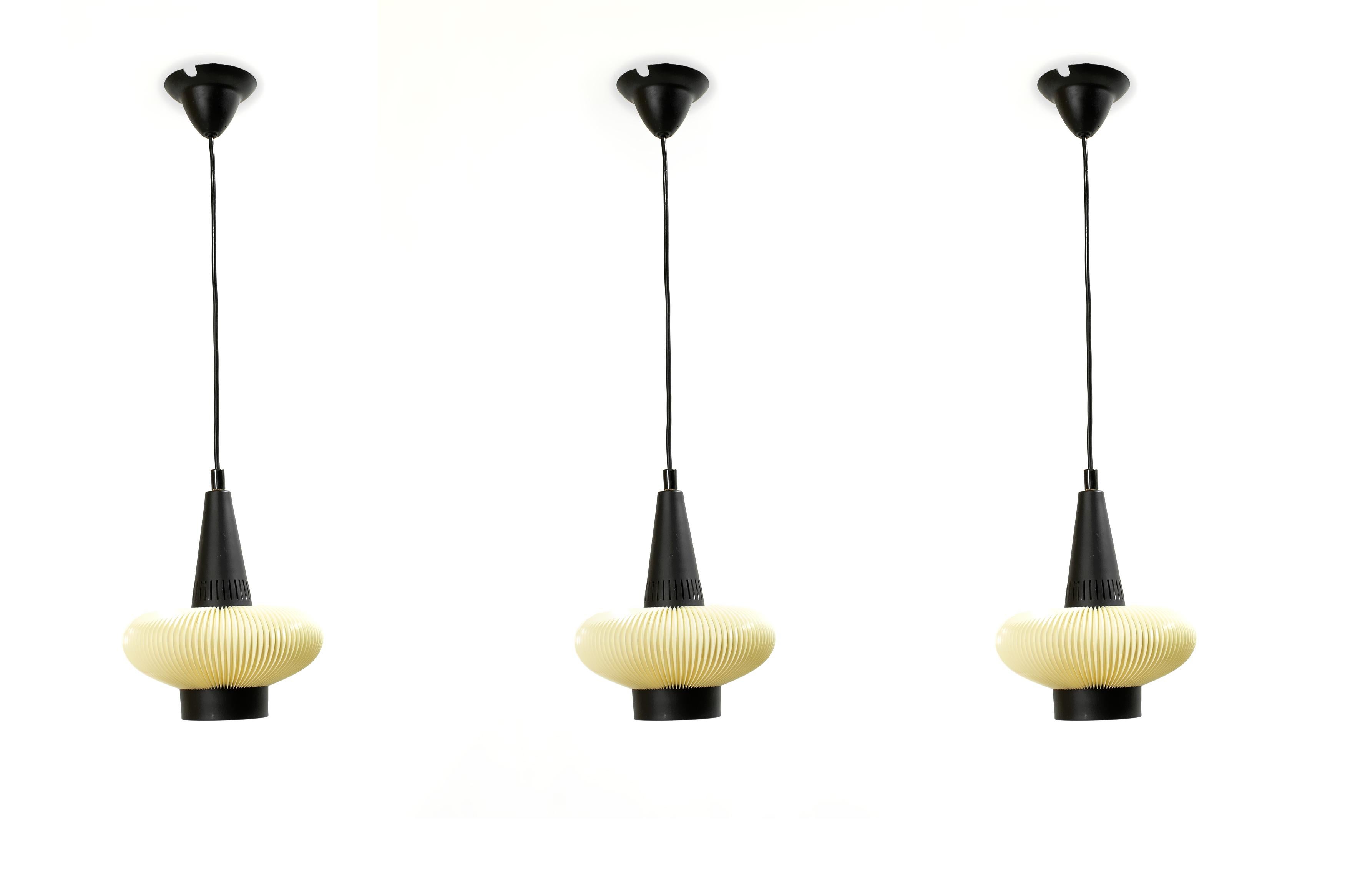 Wonderful set of three ceiling pendants in painted steel and acrylic shades. Designed and made in Norway by T. Røstad & Co. from circa 1960s second half. The lamps are fully working and in very good vintage condition. Each lamp is fitted with one