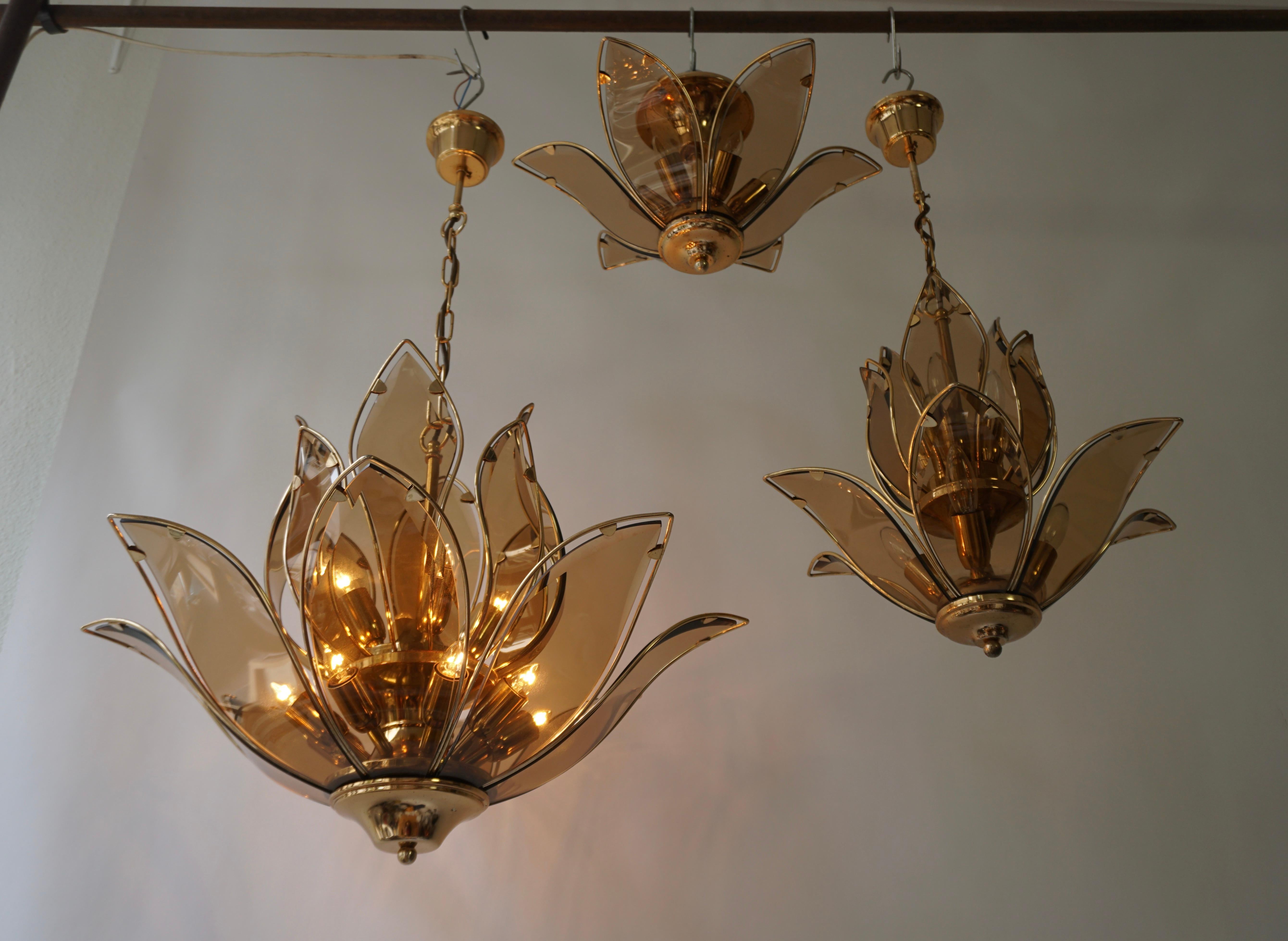 Hollywood Regency Set of Three Midcentury Chandeliers in Brass and Glass