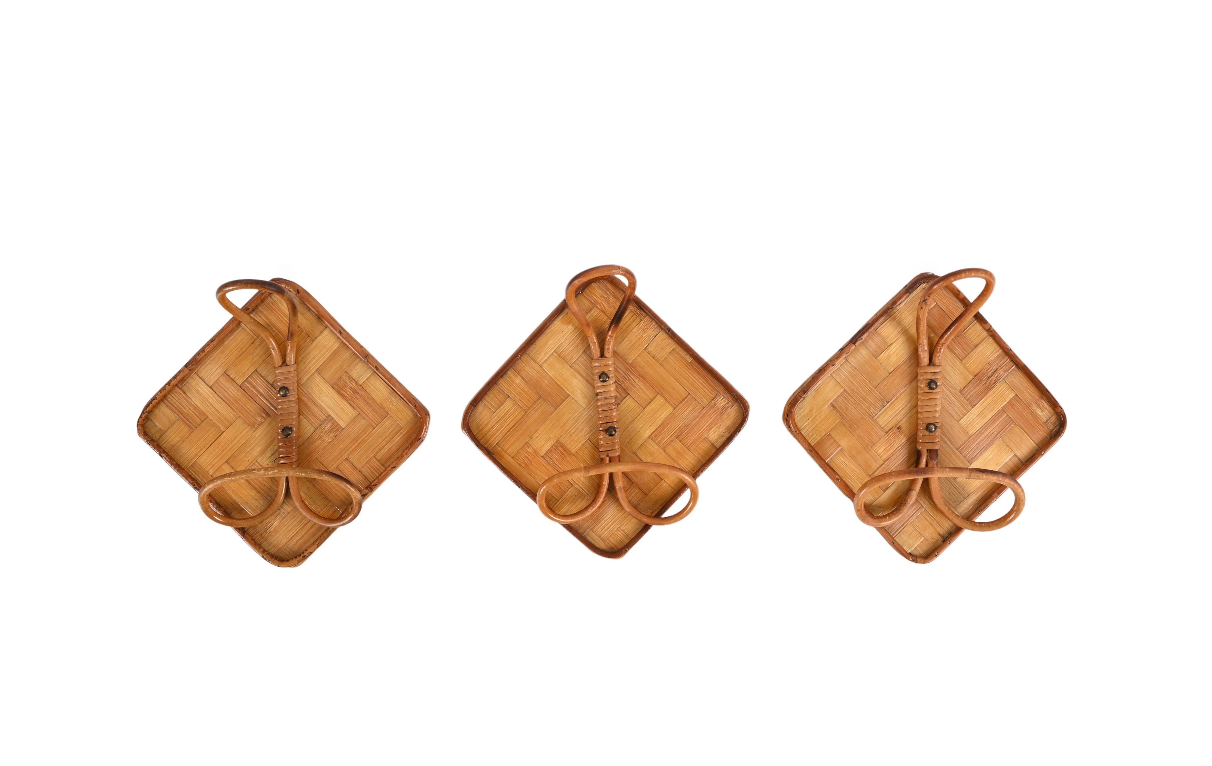 Fantastic set of three midcentury squared rattan and bamboo coat hangers. This fantastic set was designed in Italy during the 1960s following the French Riviera trend.

These unique pieces feature a slick square bamboo structure and a central hook