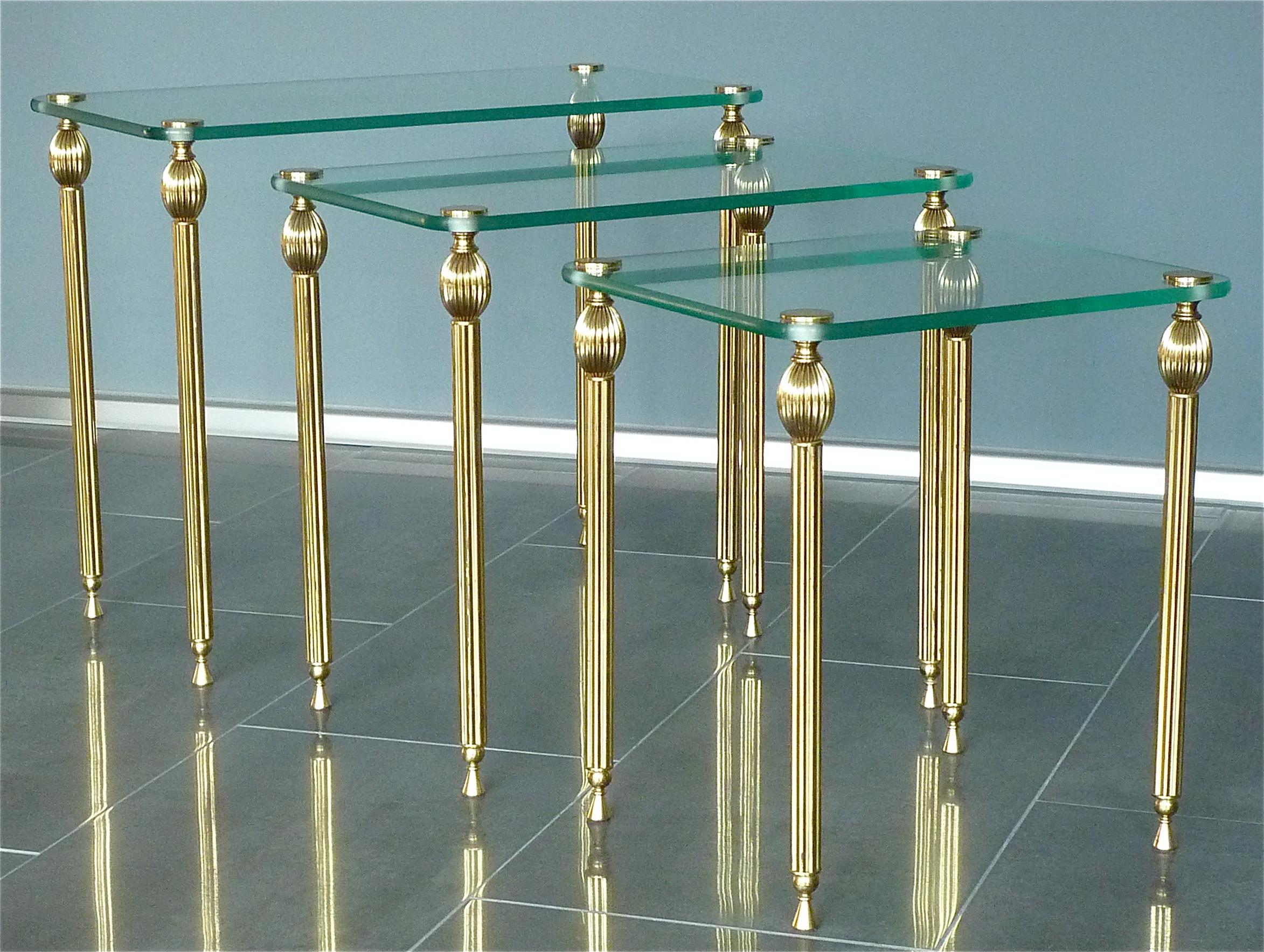 A beautiful set of three Midcentury nesting or side tables in patinated brass with slightly green tinted glass table tops made most probably by Maison Baguès or Jansen, France, circa 1955.
Dimensions of the tables:
Large: 44 cm / 17.32 inches