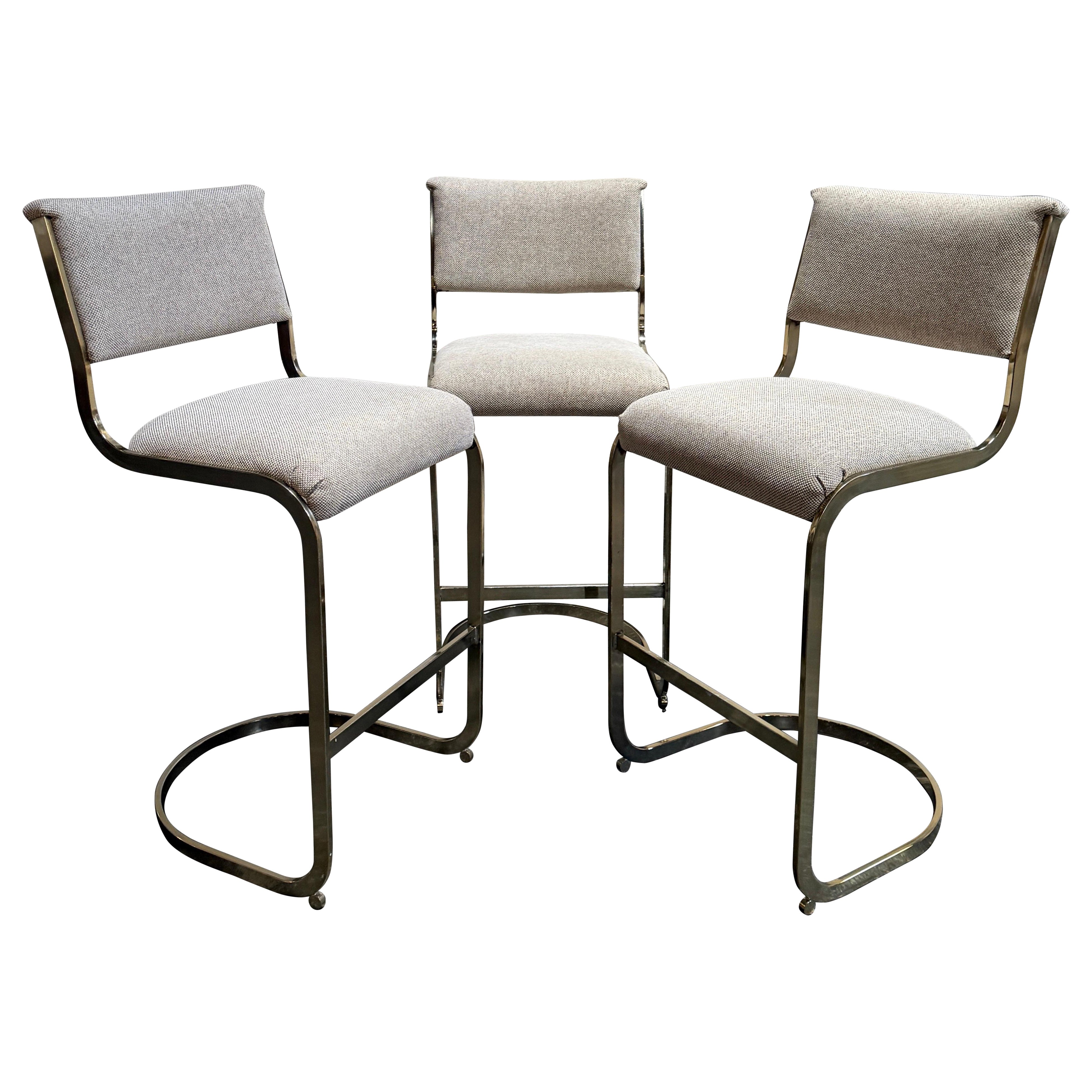 Juego de tres taburetes de bar modernistas de latón estilo Milo Baughman de Cal-Style c. 1970 en venta