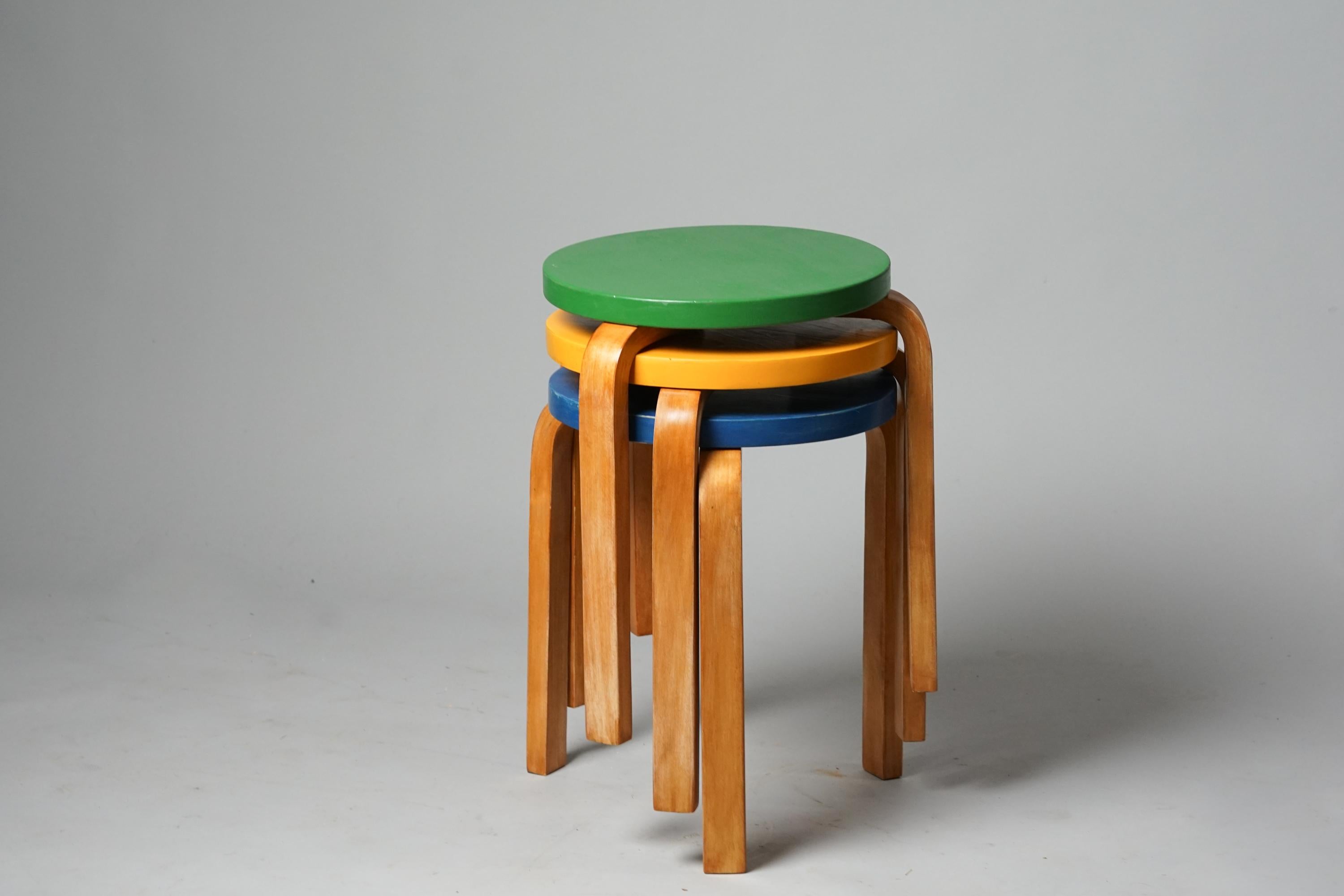 Set of three Model 60 stools, design by Alvar Aalto, manufactured by Oy Huonekalu- ja Rakennustyötehdas Ab, 1930s. Birch with painted seat. Good vintage condition, minor patina and wear consistent with age and use. The stools are sold as a set.