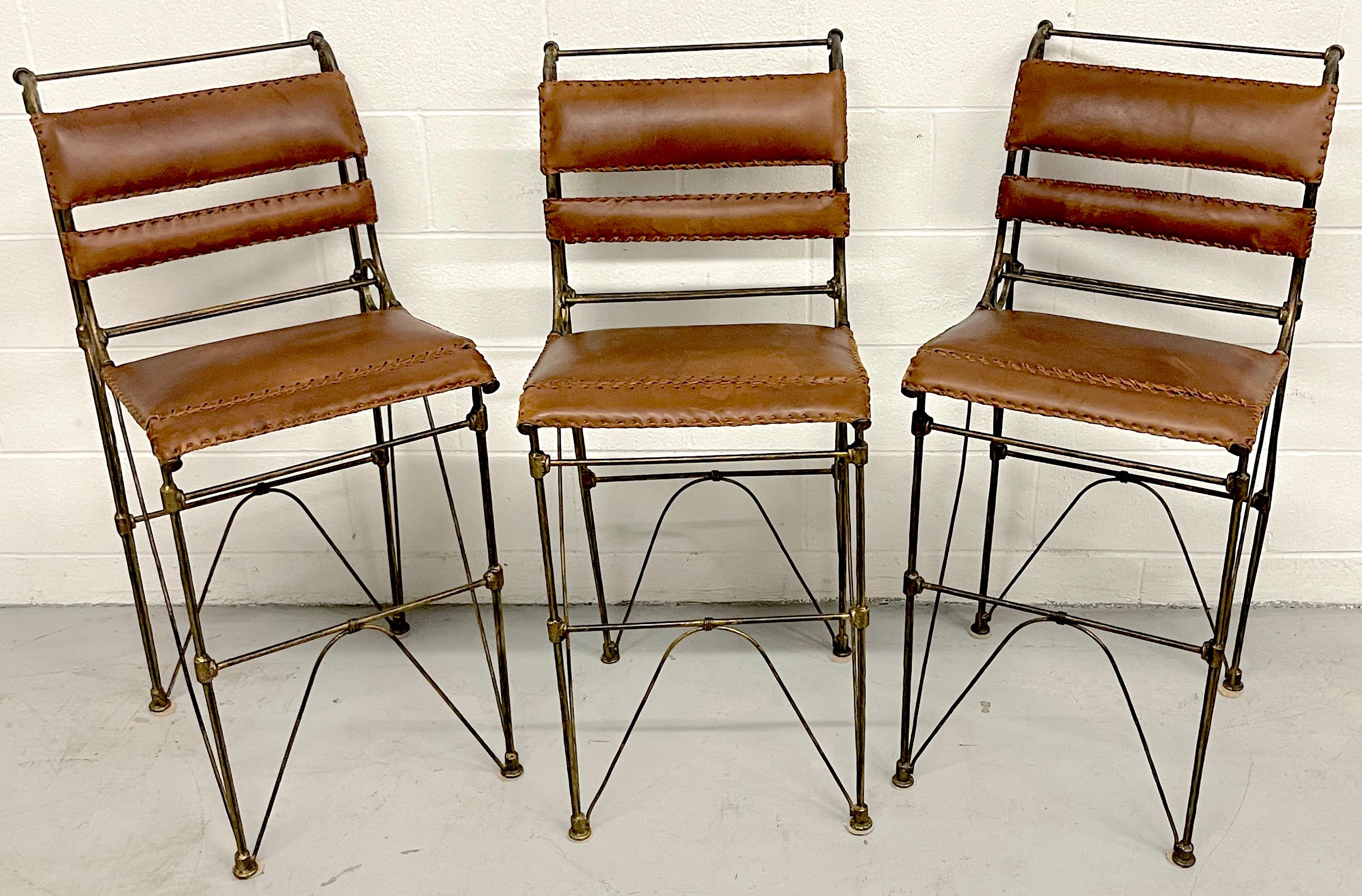 Set of three modern iron & stitched leather barstools.
USA, later 20th century.
A stunning set of three sculptural wrought iron bar stools with stitched Saddle leather backrests and seats. The design of the barstools show influences of famed