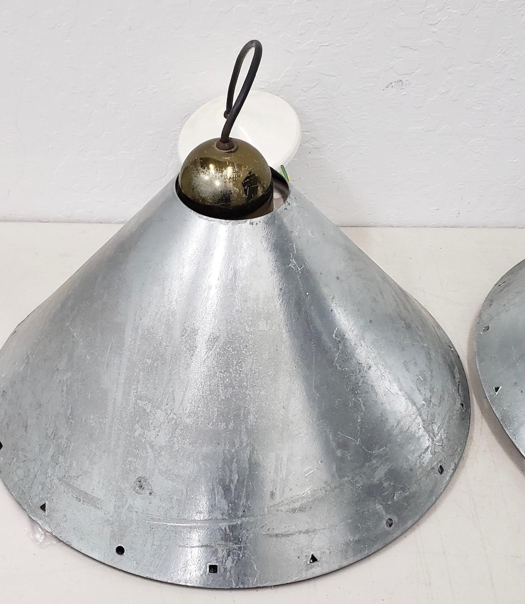 Set of three modernist steel and zinc hanging lamps by Ron Rezek circa 1980

Dimensions 17