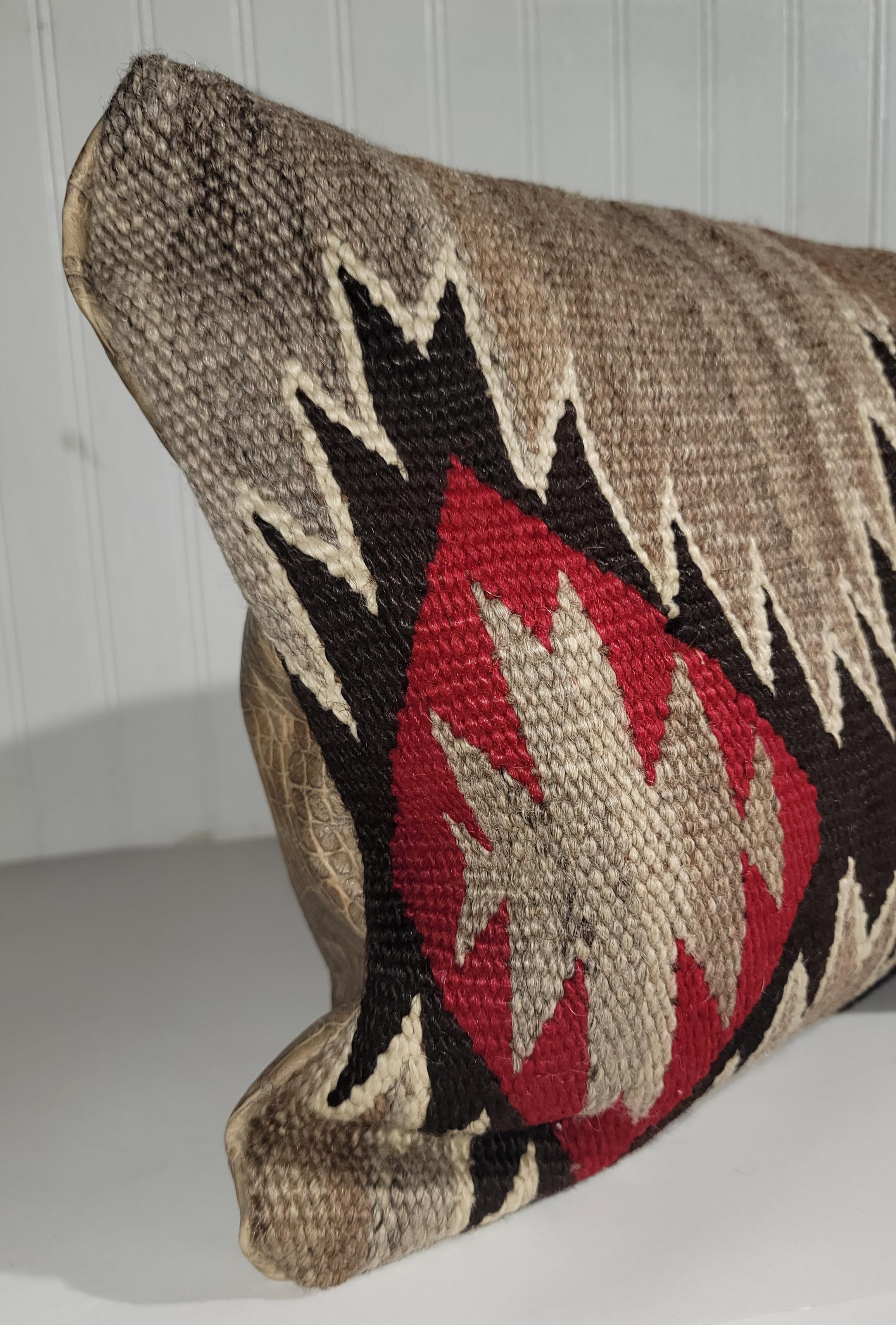 Wool Navajo weaving made into a pillow with crocodile leather backing. the inserts are down and feather filled for comfort and are hypoallergenic. 

The largest pillow measures
27 x 10 
medium - 26 x12 
small - 19.5 x 11