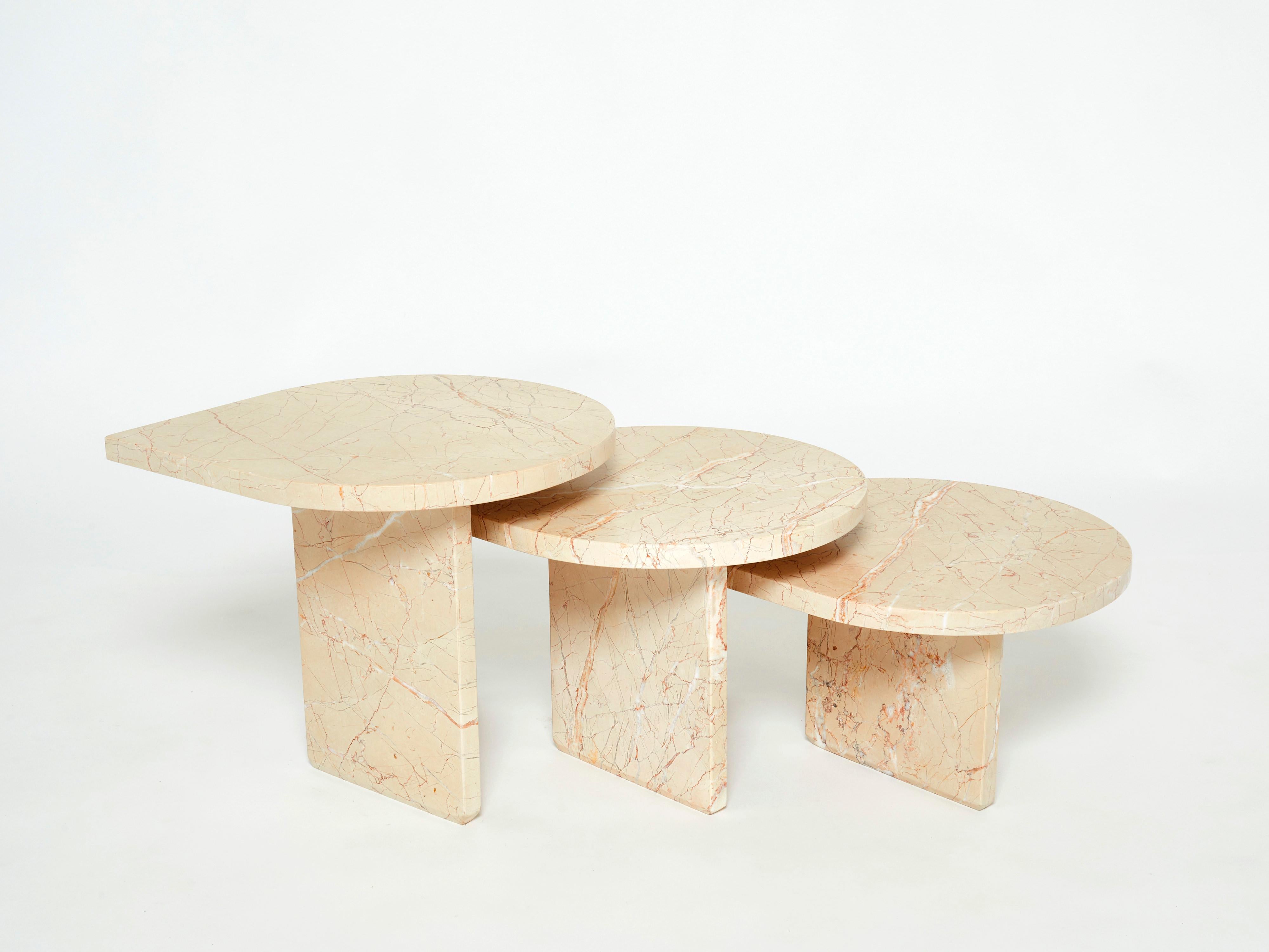 Unique set of three nesting tables made in France in the early 1970s from a beautiful sicilian light pale pink marble. The thick surface of each table is slick yet intriguing, with a beautiful and original shape. The result is a sophisticated,