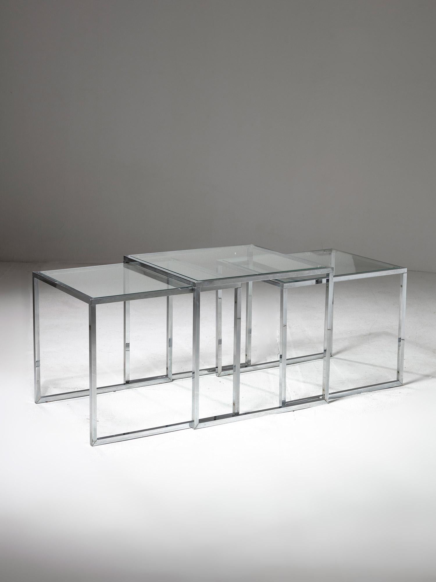 Set of three nesting / stacking side tables.
Squared steel frame and glass top, these versatile pieces can expand on both horizontal and vertical dimension, or also used separately.
Size refers to the largest piece.