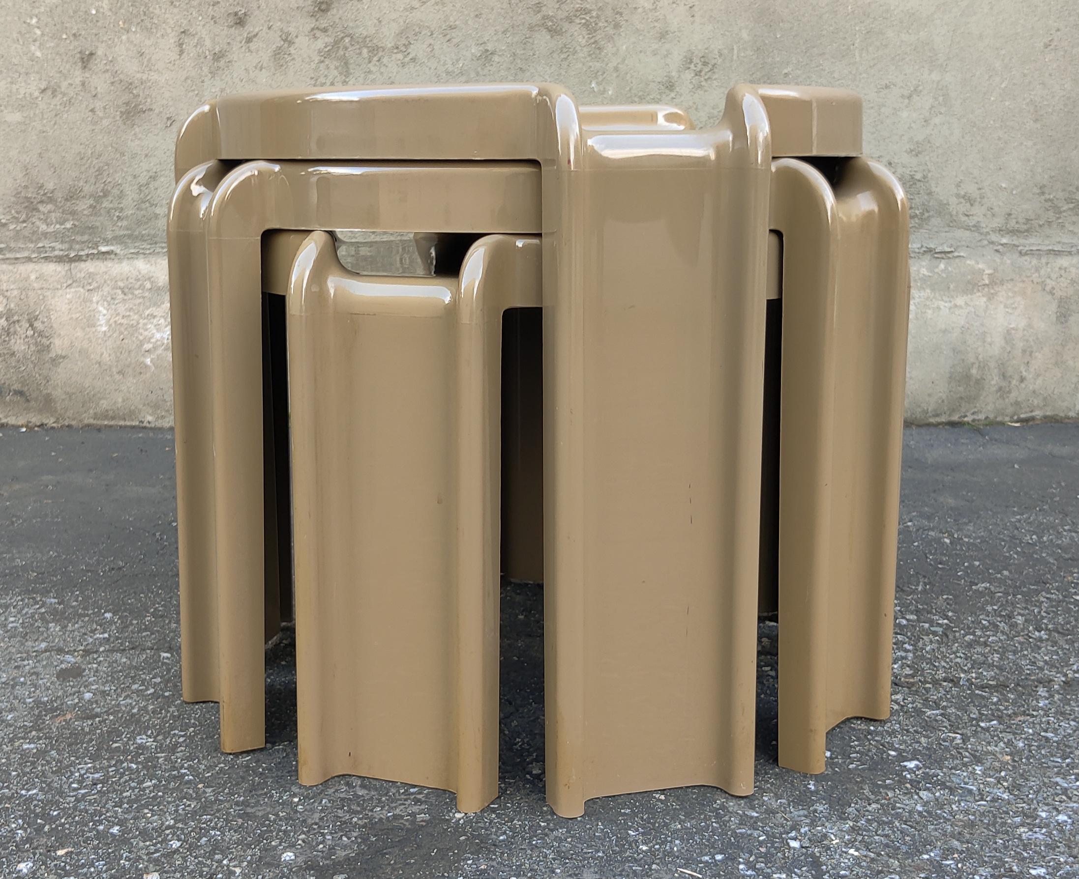 A set of three futuristic or space-age plastic nesting tables by Giotto Stoppino for Kartell. Made in Italy circa 1970s. All three are signed. It's a little tricky to describe the color of these tables. A medium grey that is very pleasing. The