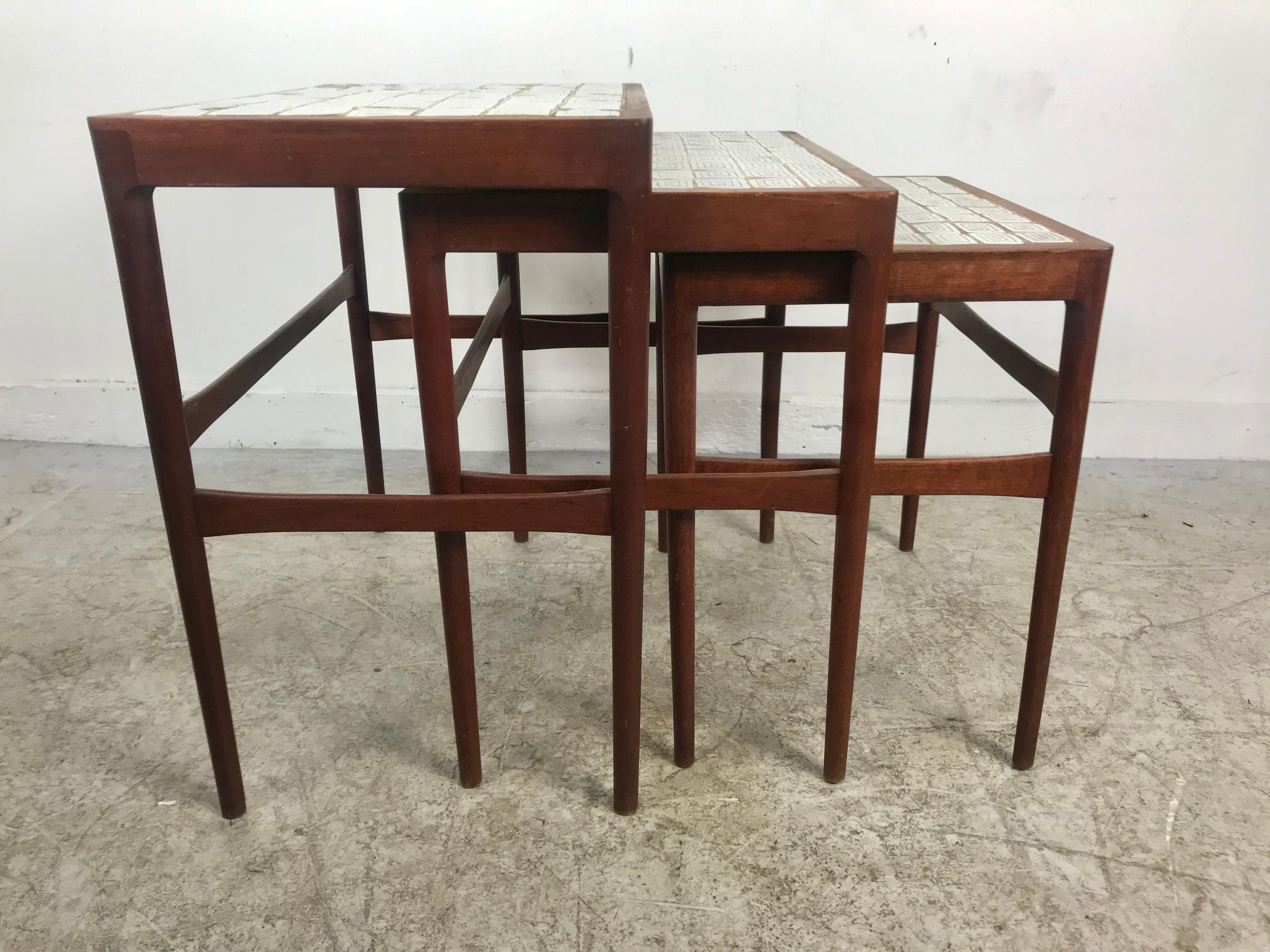 Danish Mid-Century Modern teak set of three nesting tables designed by Knud Mortensen for the prestigious Illums Bolighus, Kobenhavn store and made by Soren Horn (Danish cabinetmaker actif in the mid-20th century). Rectangular top with inset glazed