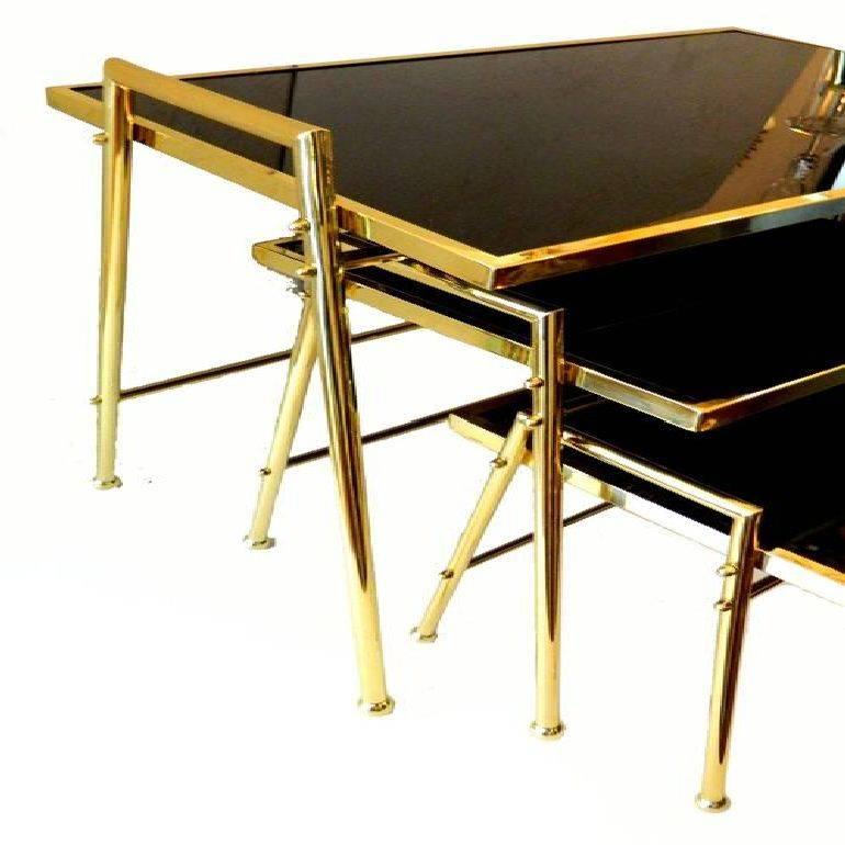 Three very elegant French black glass tops nesting tables designed by Maison Jansen. Measurements: 1) 20
