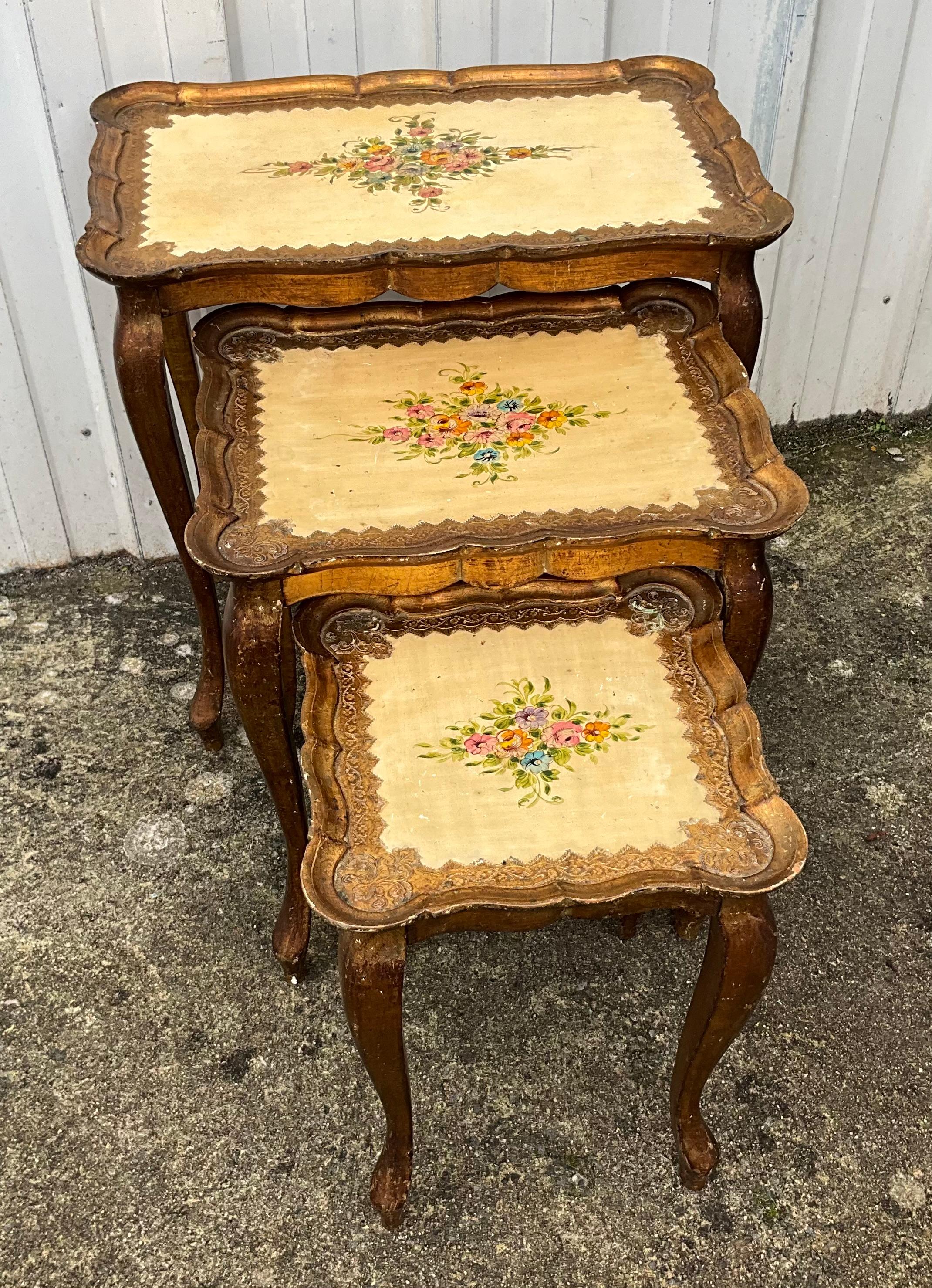 This remarkable set of three gilded wooden nesting tables originates from an elegant bourgeois residence in the heart of the Loire Valley. These exceptional pieces once belonged to a distinguished notary, who took great care in furnishing his grand