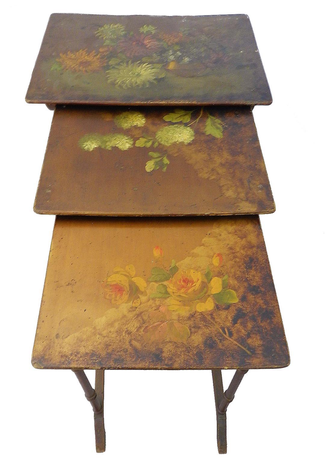 Set of 3 antique nest of tables nesting tables hand painted individual one of a kind floral tops, French, circa 1880
Gloriously distressed through time
Superb original flower paintings 
Legs bronze with gold
Age worn patina 
Good antique
