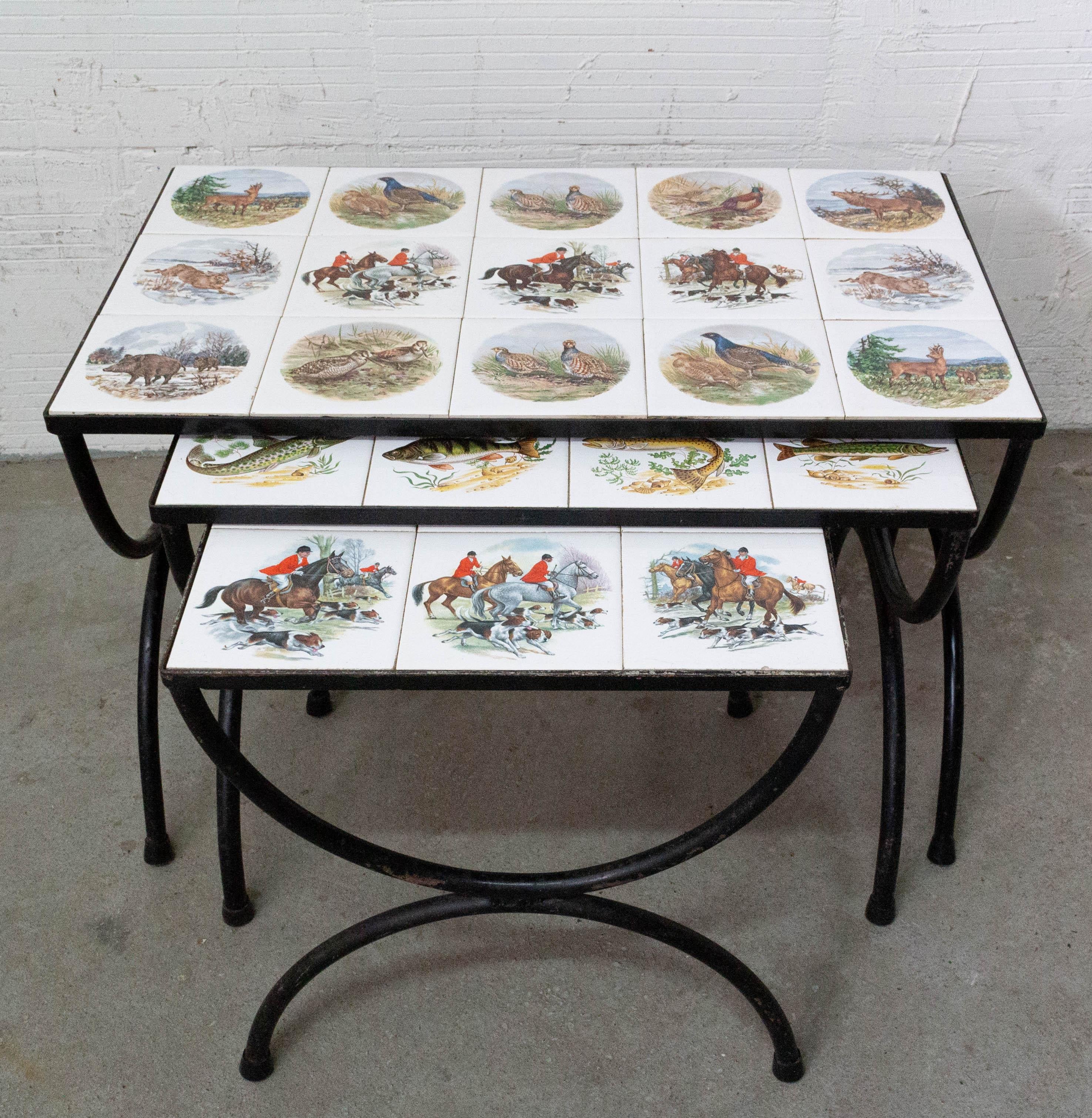 Three nesting vintage tables hunting sceneries and fishes, French, circa 1960
The biggest one is representing game, the two little tables are nesting tables representing fish and hunting parties.
They can be used as coffee and end
