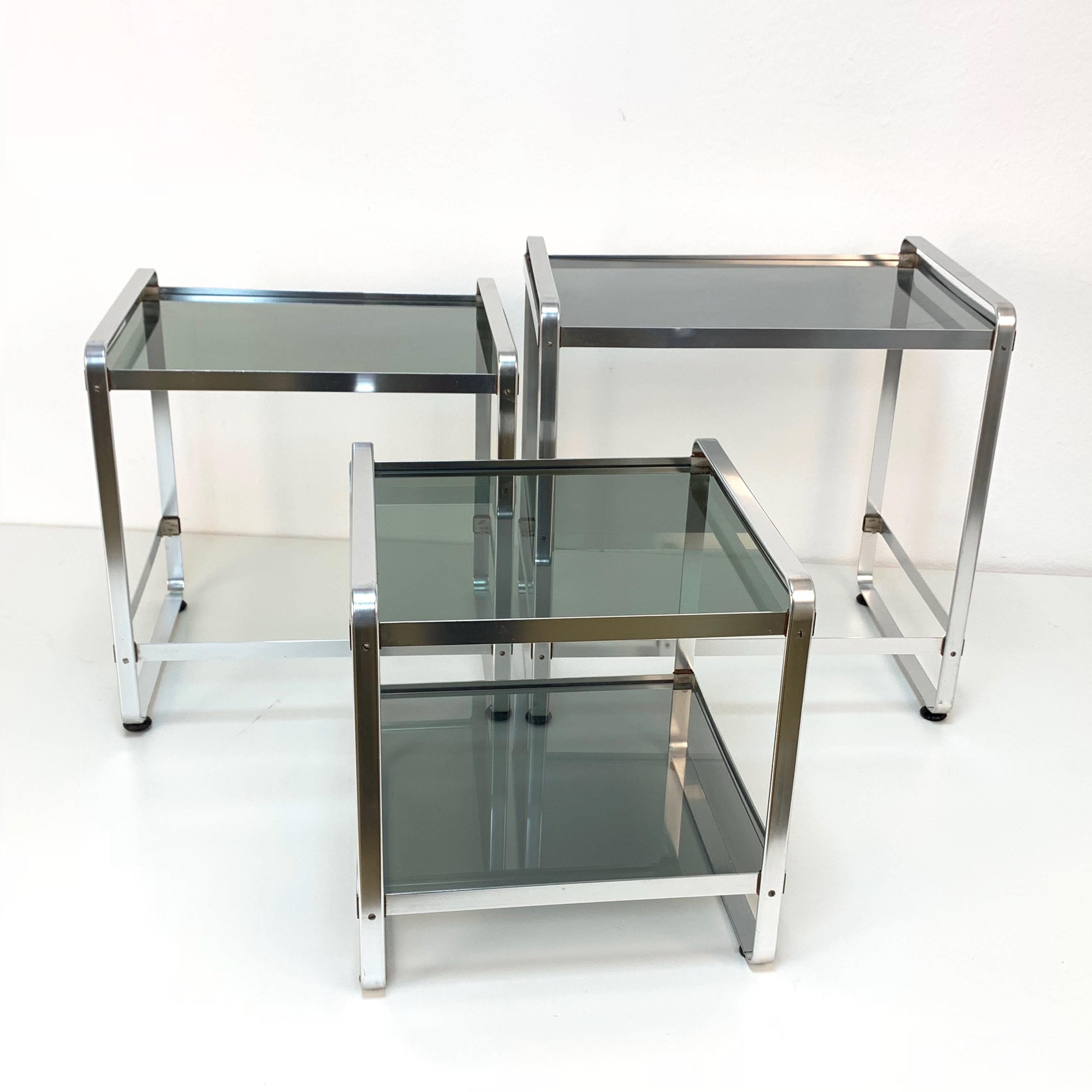 Nesting tables in aluminum and smoked glass, Italy, 1970s Mid-Century Modern.
Large table dimensions; Width 18.3, depth 13.4, height 18.5.