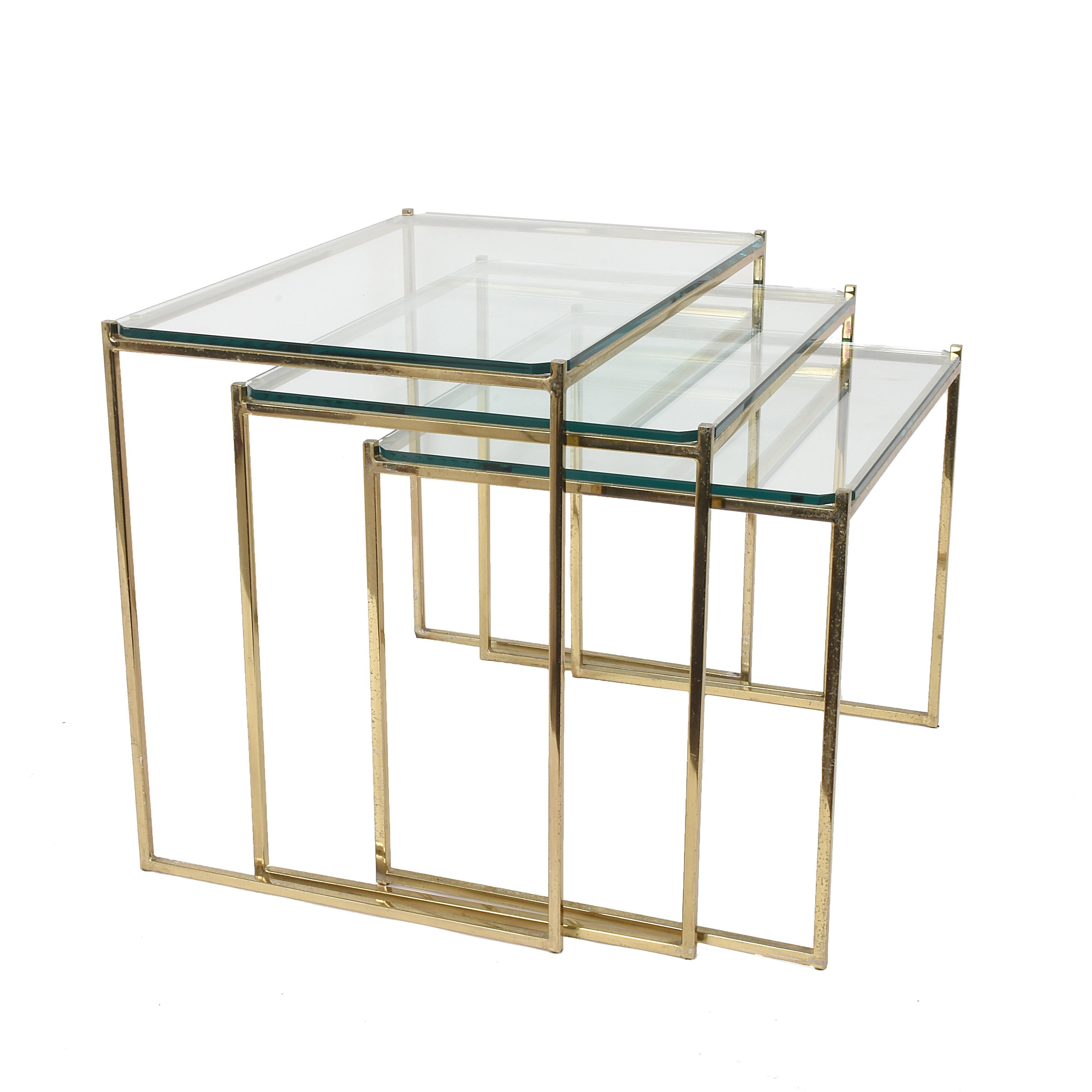 Nesting tables in brass and crystal Italy 1970s Mid-Century Modern 
Dimensions; Width 14.56, depth 21.25, height 18.11
Dimensions; Width 14.56, depth 16,14, height 16.33
Dimensions; Width 14.56, depth 18.30, height 14.37.