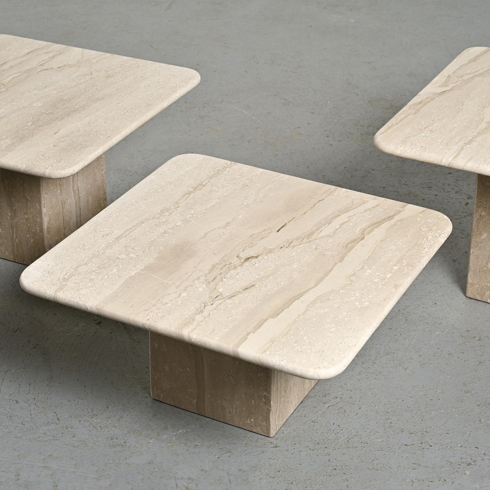 This set of travertine nesting tables, from the 1970s, elegantly blends the natural strength of travertine with the clean lines of geometric design.

Featuring square tops supported by square bases, these tables offer versatile arrangement options,