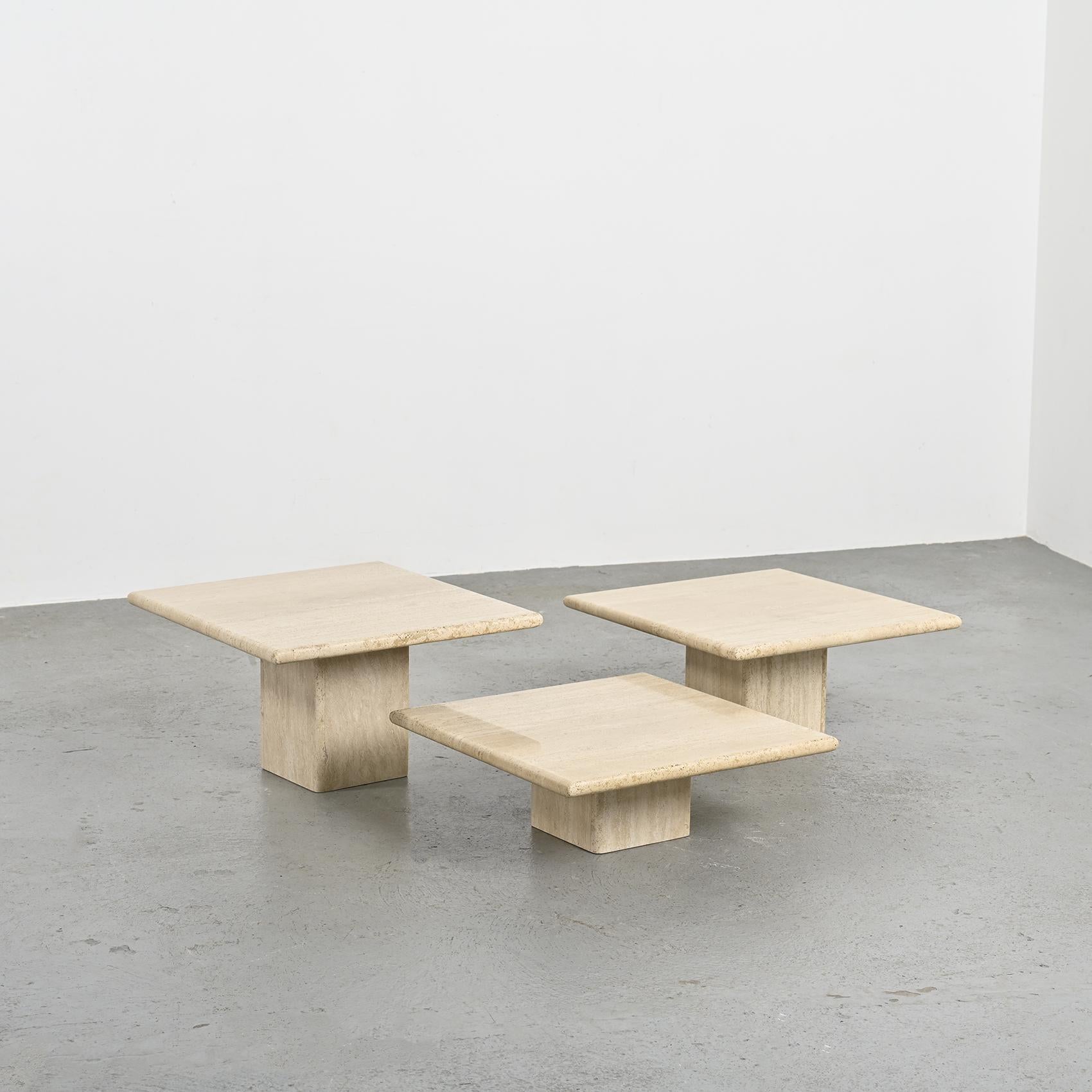This set of travertine nesting tables, from the 1970s, elegantly blends the natural strength of travertine with the clean lines of geometric design.

Featuring square tops supported by square bases, these tables offer versatile arrangement options,