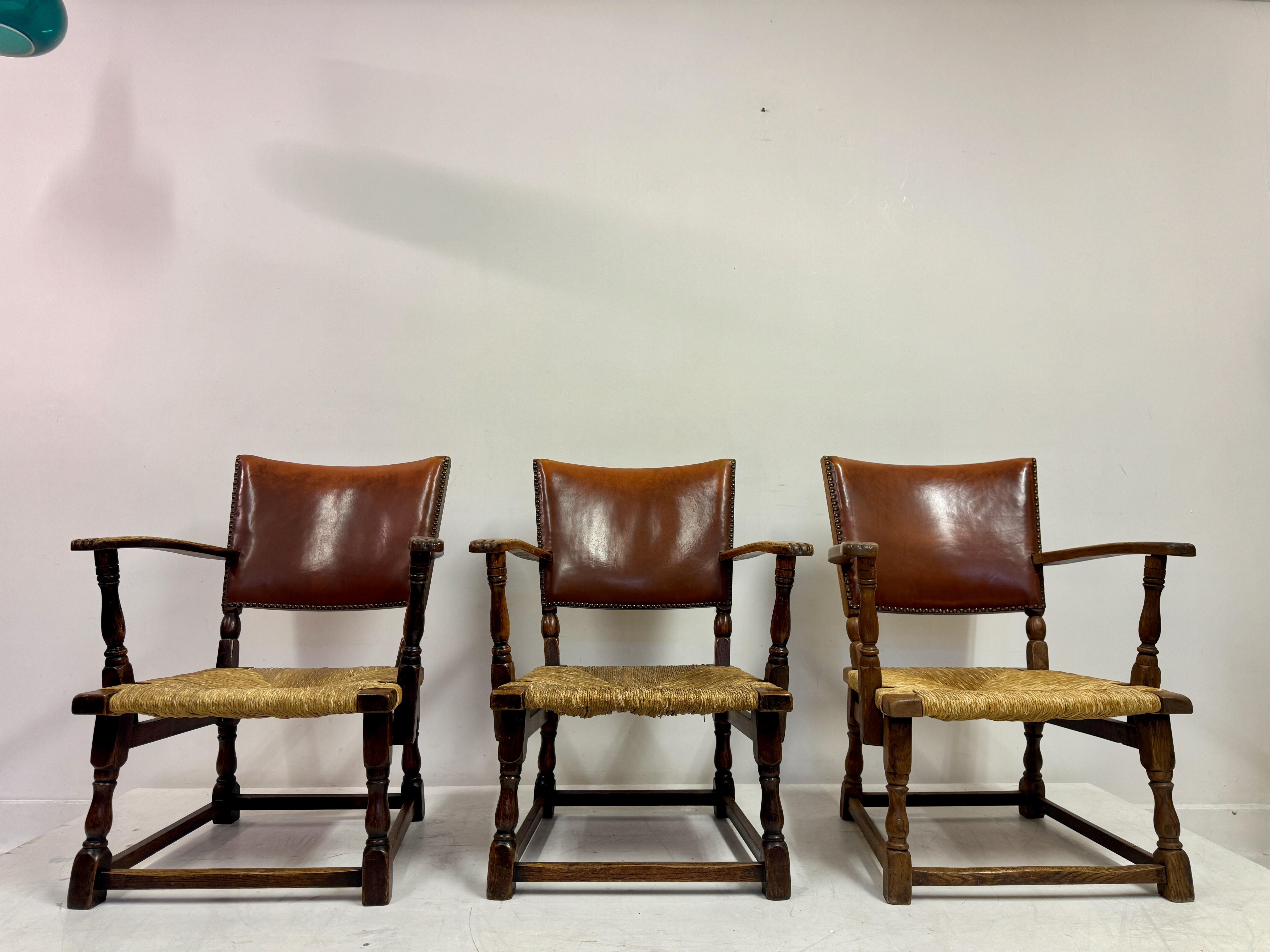 Three armchairs

Oak

Rush seat with leather back

Seat height 36cm

Dutch 1940s