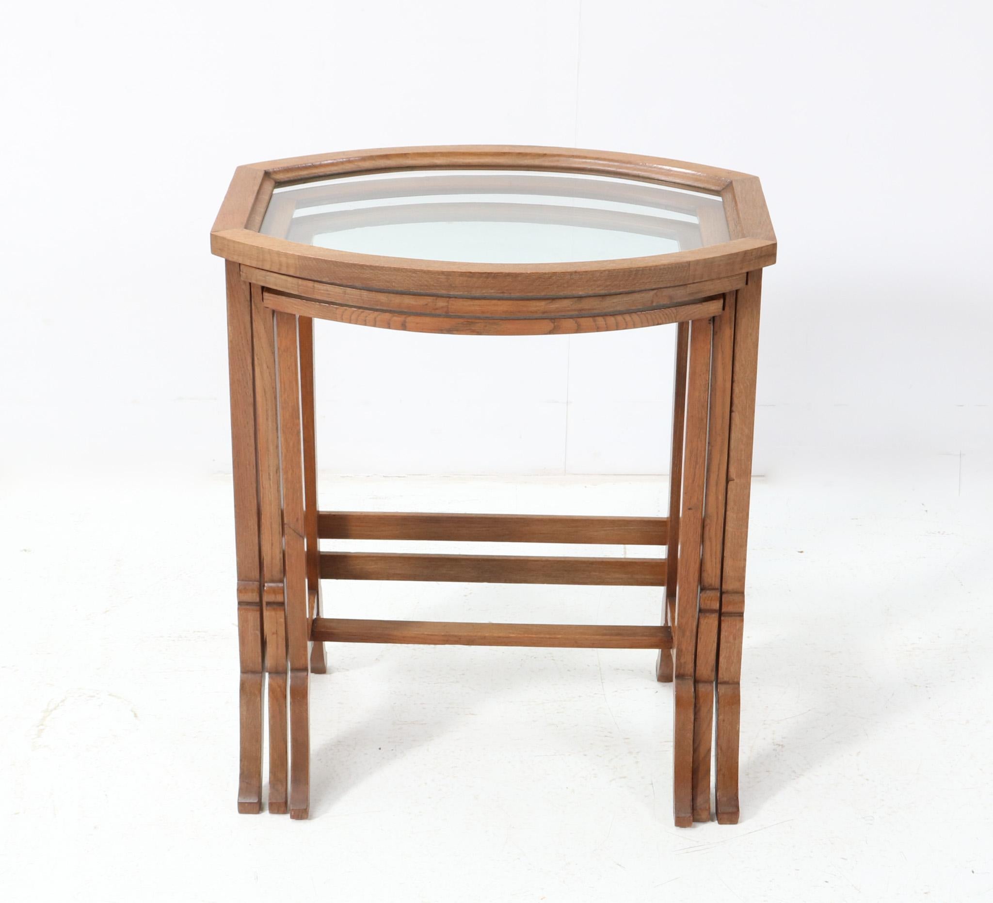 Stunning and rare set of three Art Nouveau nesting tables.
Solid oak and elegant shaped frames with glass tops.
This wonderful set of three Art Nouveau nesting tables is in very good original condition with minor wear consistent with age and use,