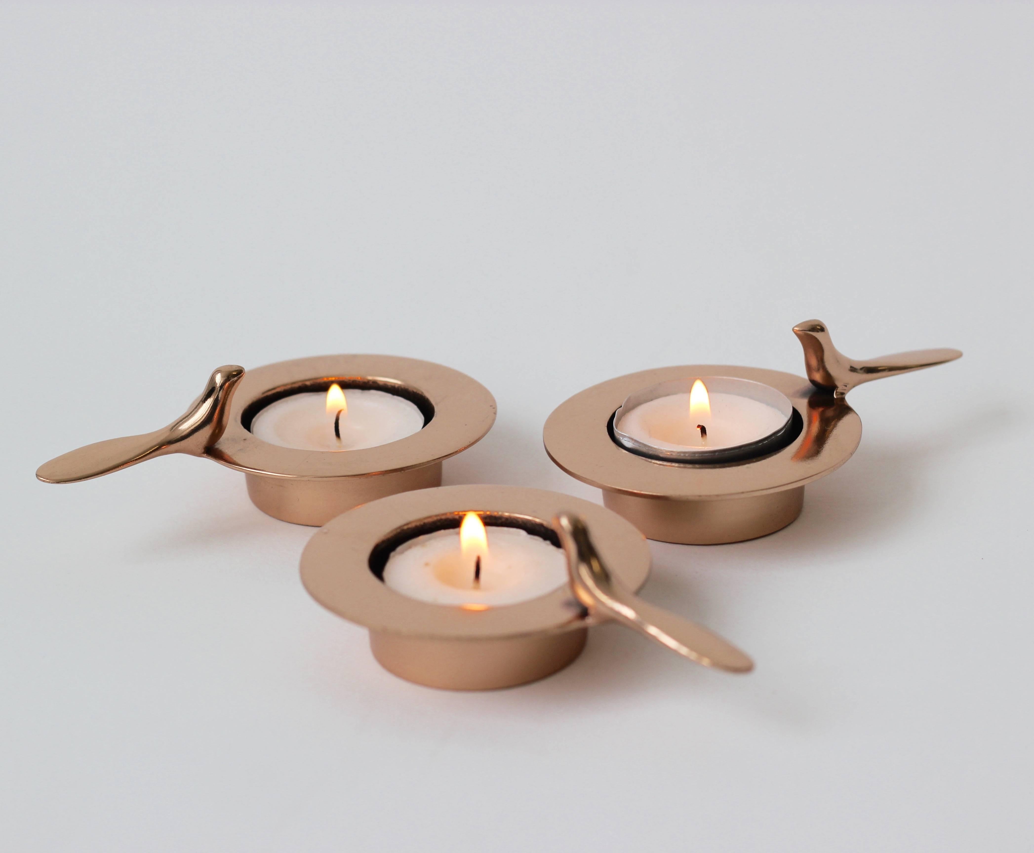 Set of three each of those original and elegant bronze tea light holders is handmade individually. Cast using very traditional techniques, they are polished revealing the lustrous finish of this beautiful material.

Those decorative elements are