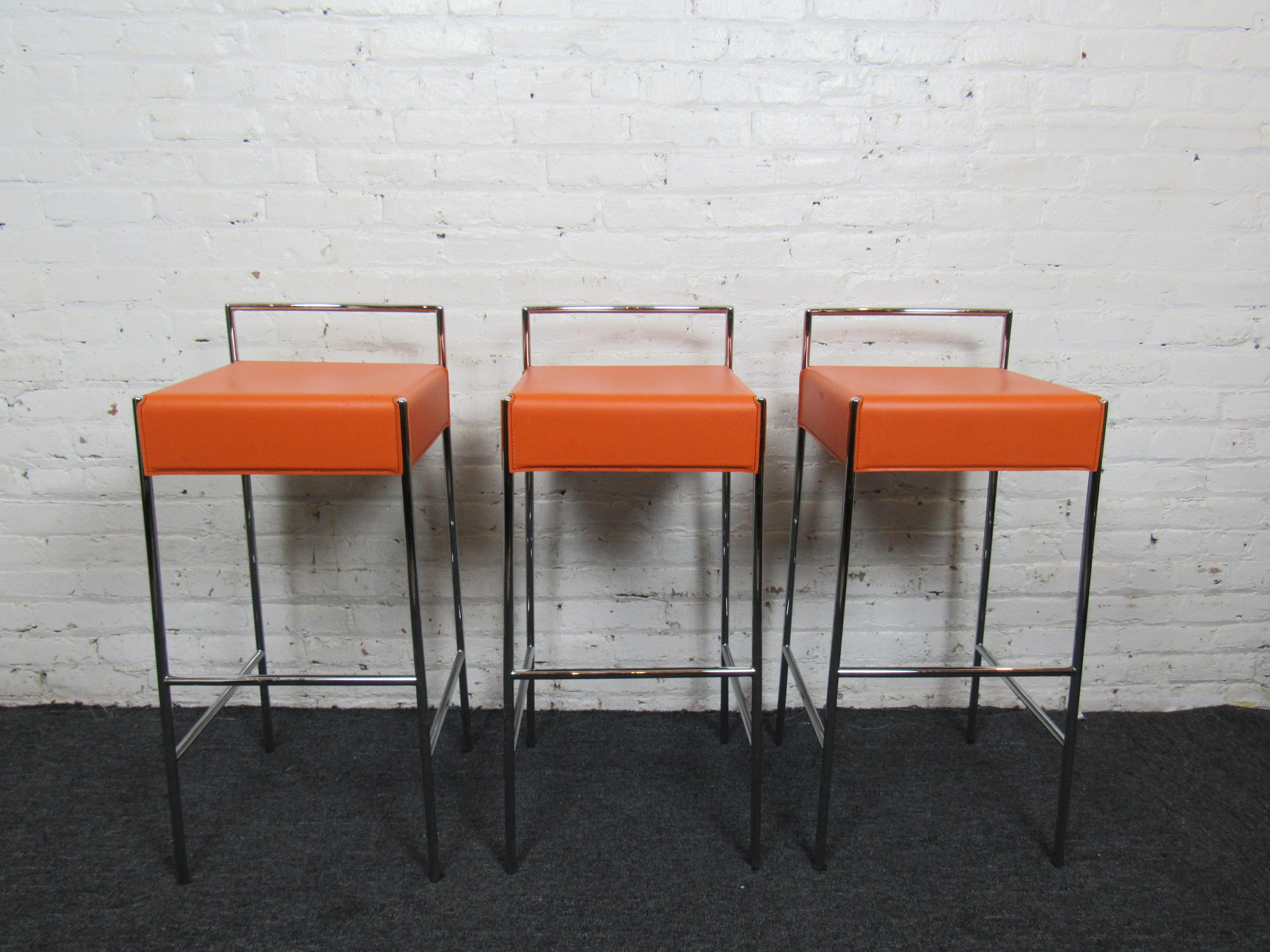 Three stylish orange stools made in Italy. Faux leather seats with chrome legs. 
(Please confirm item location - NY or NJ - with dealer).
 