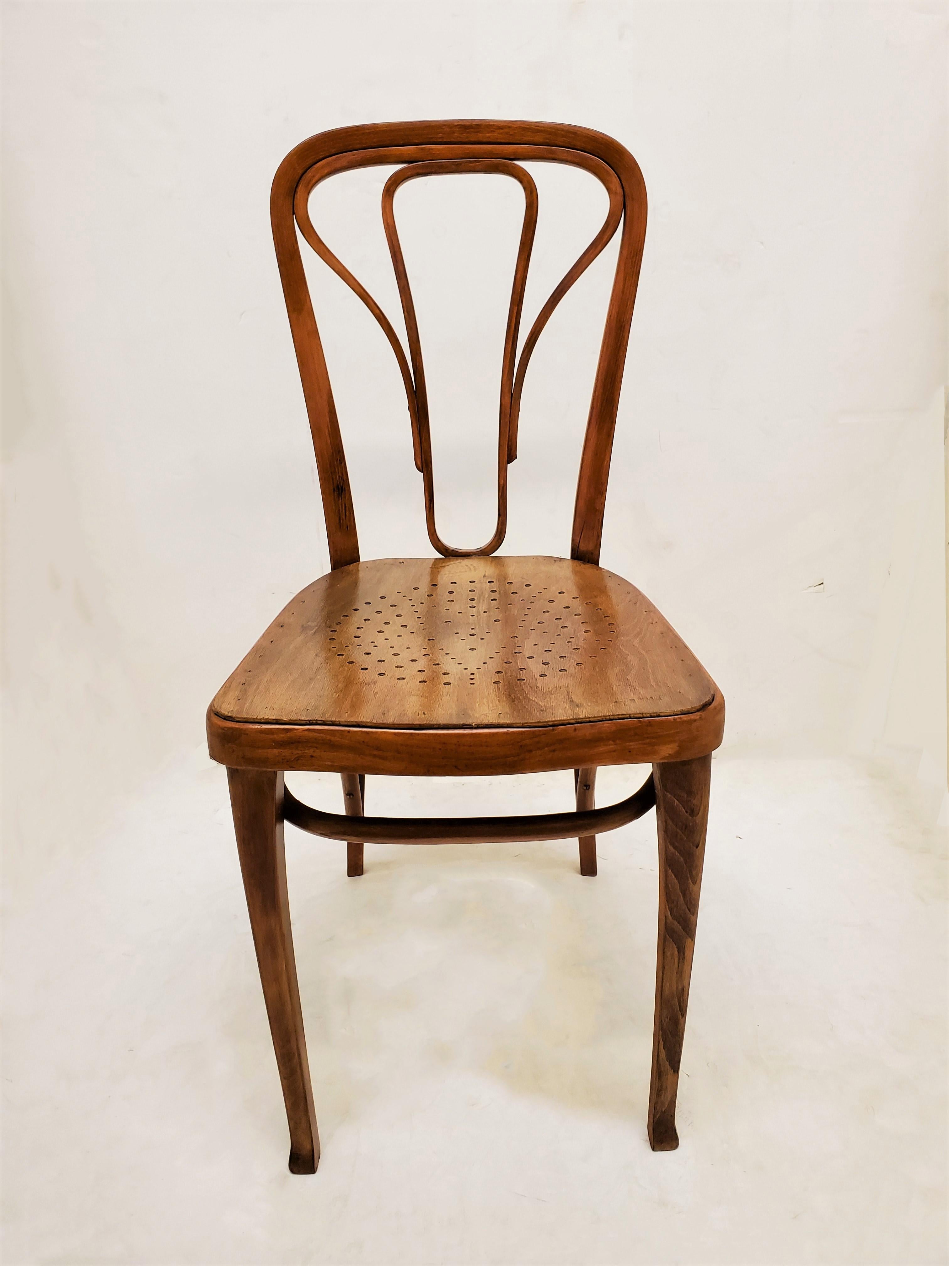 Original period Austrian, Wiener Werkstätte bentwood wood bistro chairs by manufacturer Thonet 1870-1956 . These authentic and elegant chairs feature sinuous steamed wood in an organic style with Bauhaus, Vienna Secession details. 
Double curved