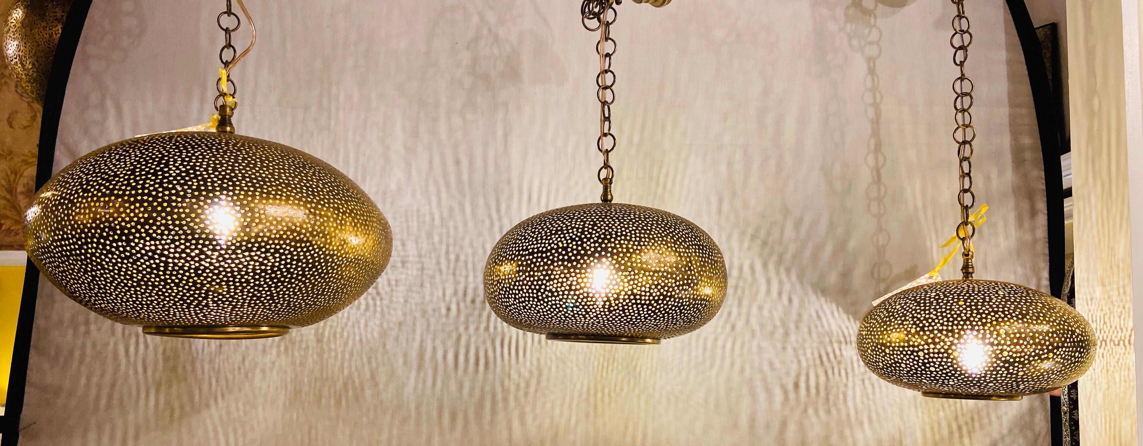 Set of Three Oval Shaped Brass Pendant Chandeliers in Graduating Sizes 12