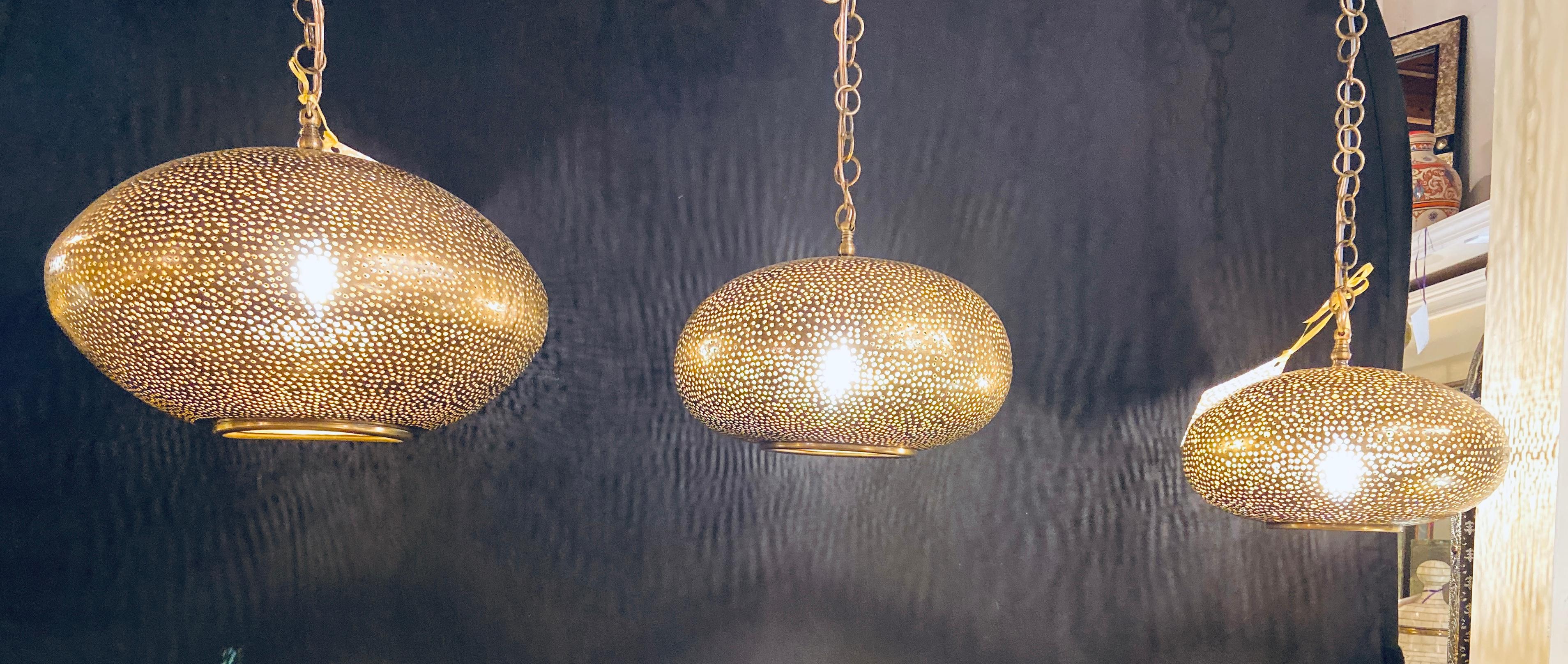 Moroccan Set of Three Oval Shaped Brass Pendant Chandeliers in Graduating Sizes